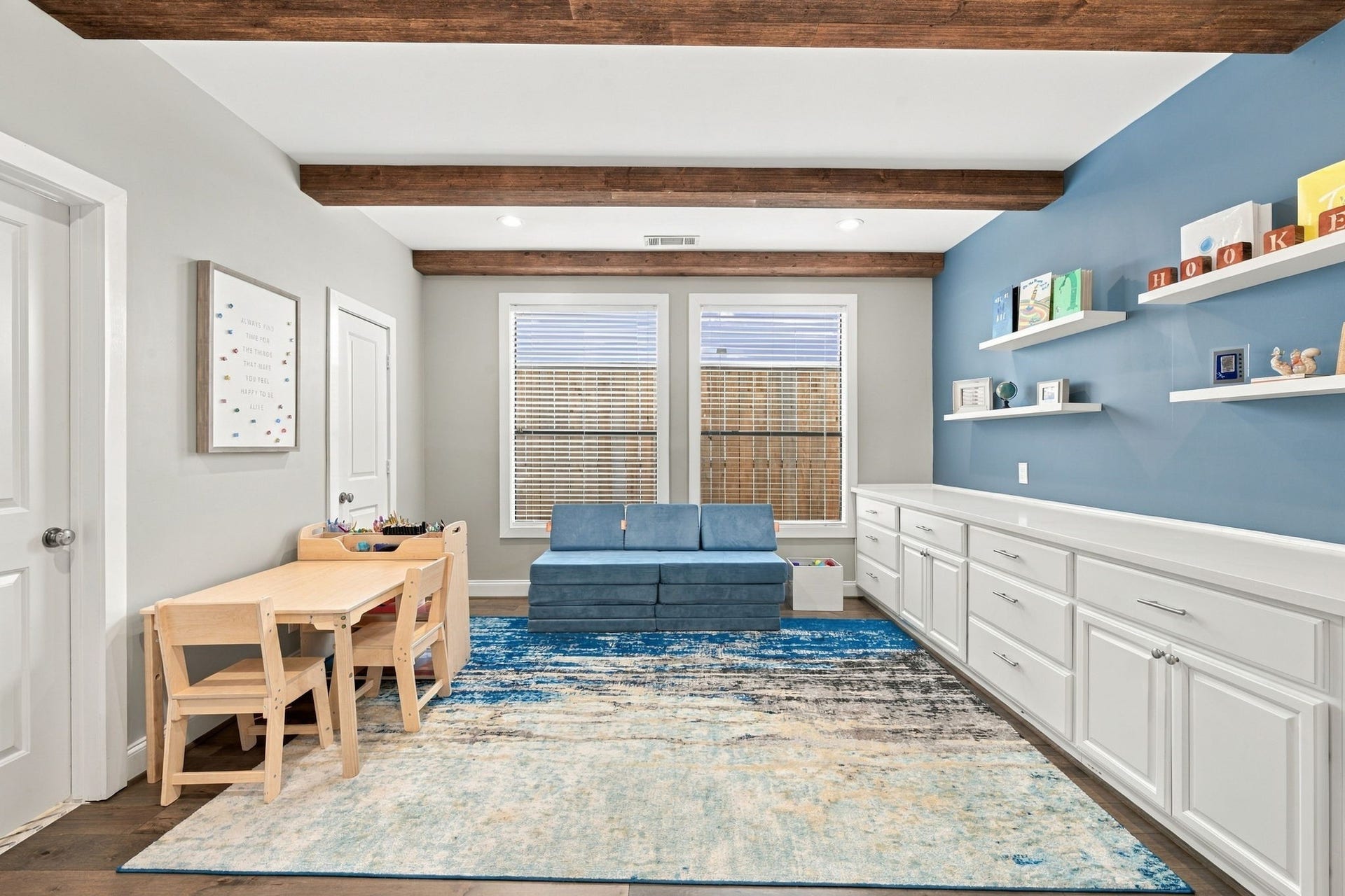 Versatile first-floor room currently used as a playroom, offering flexibility as a home office or additional bedroom. Features beautiful hardwood floors, decorative wood ceiling beams, recessed lighting & large windows bringing in natural light. Includes a closet & access to a full bath.