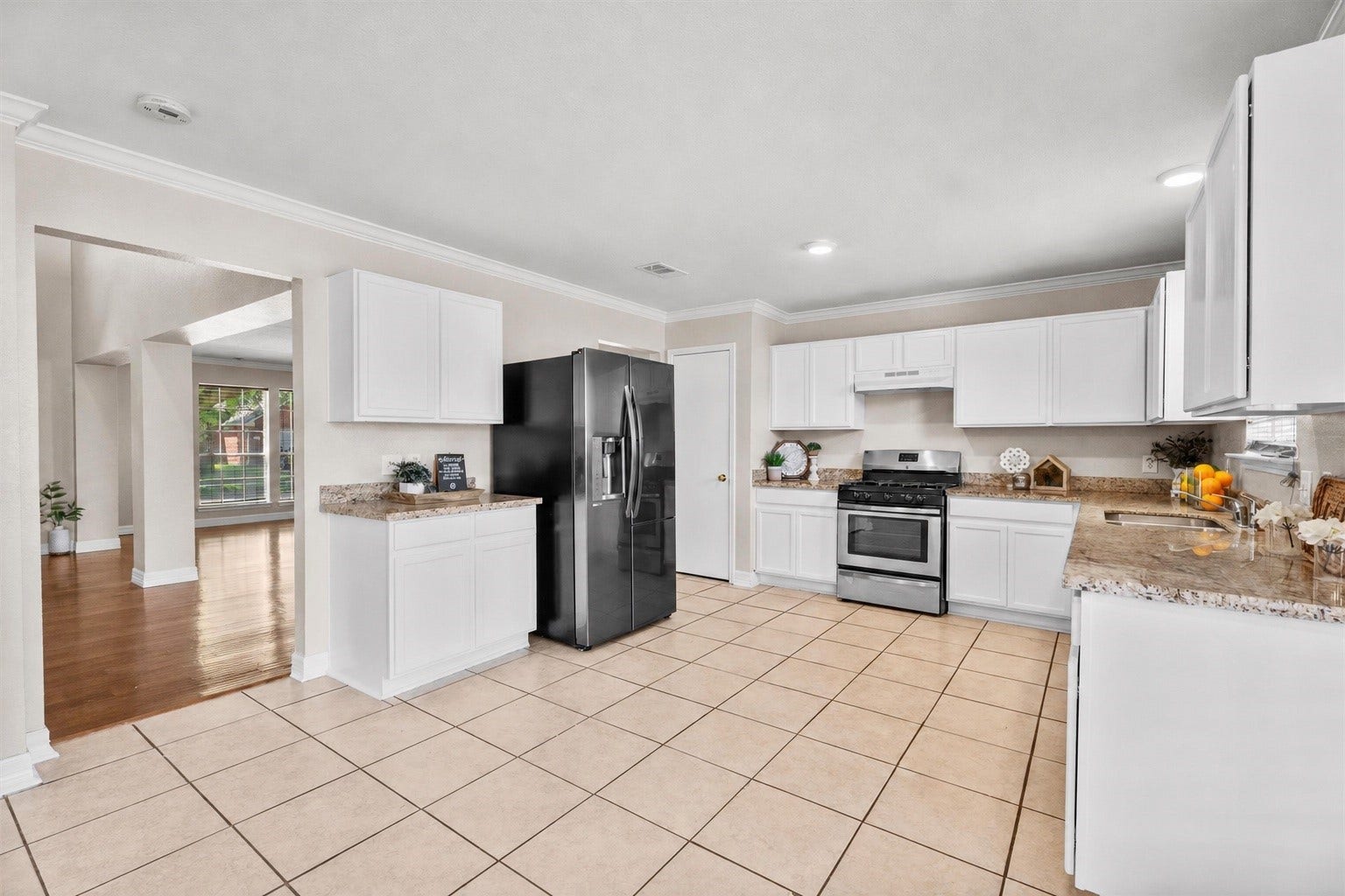 5918 Stirring Winds Lane, Houston, TX 77086 Spacious kitchen featuring abundant cabinet storage, generous counter space, gas cooking, and a functional layout that flows seamlessly into the living areas.