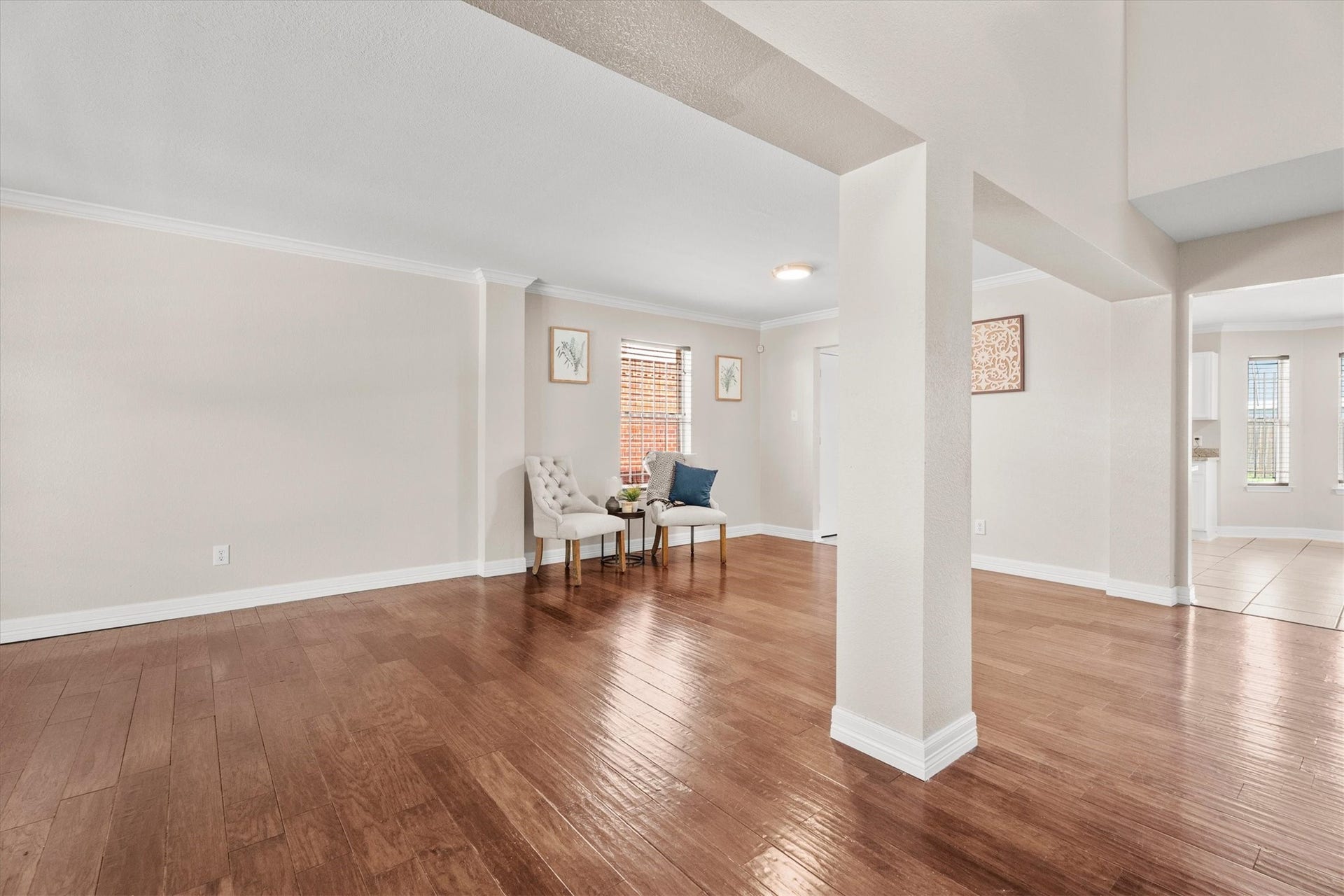 5918 Stirring Winds Lane, Houston, TX 77086 Open and inviting front living and formal dining areas featuring rich wood flooring and abundant natural light.