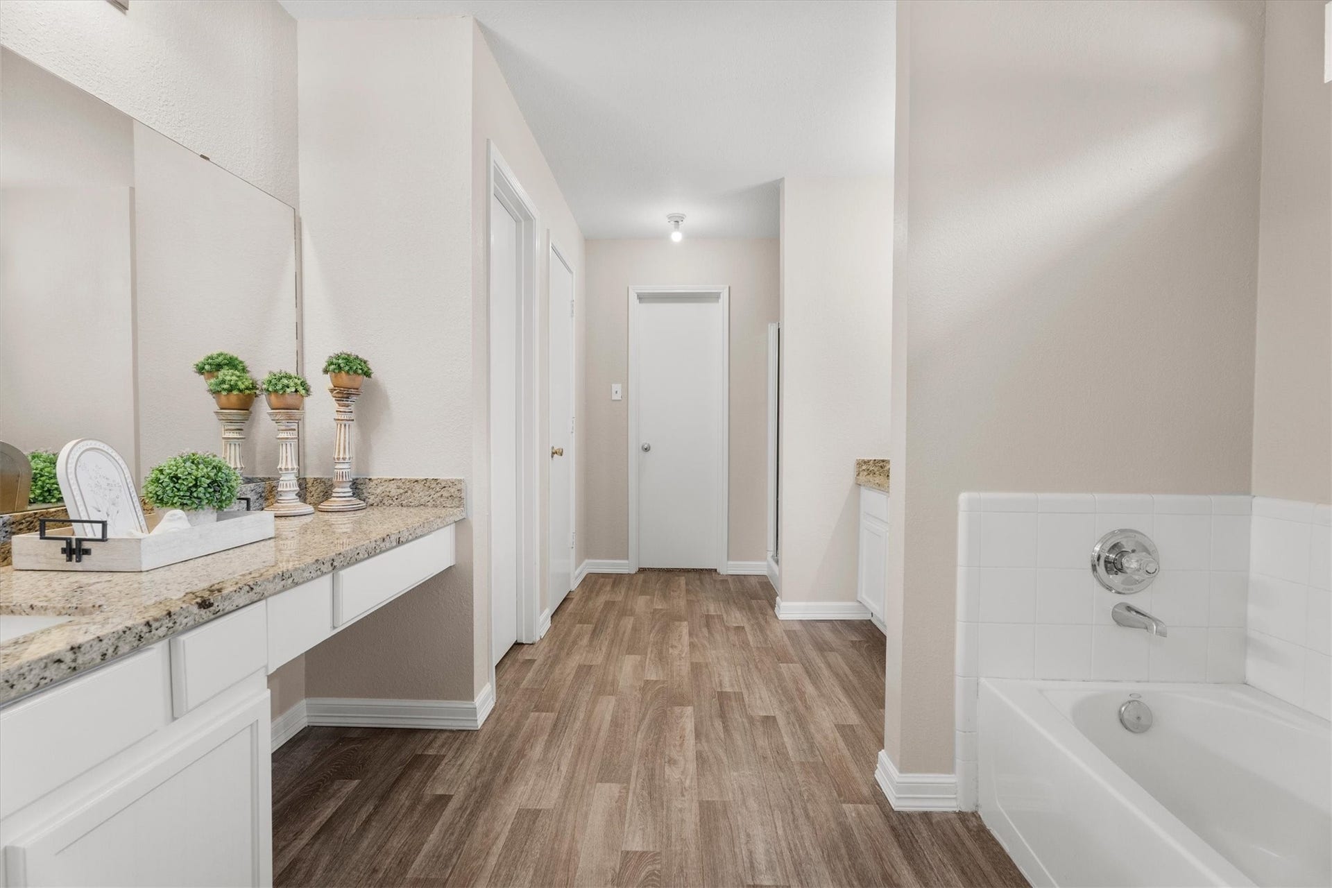 5918 Stirring Winds Lane, Houston, TX 77086 Spacious primary bath featuring dual vanities, a soaking tub, separate shower, and generous storage.