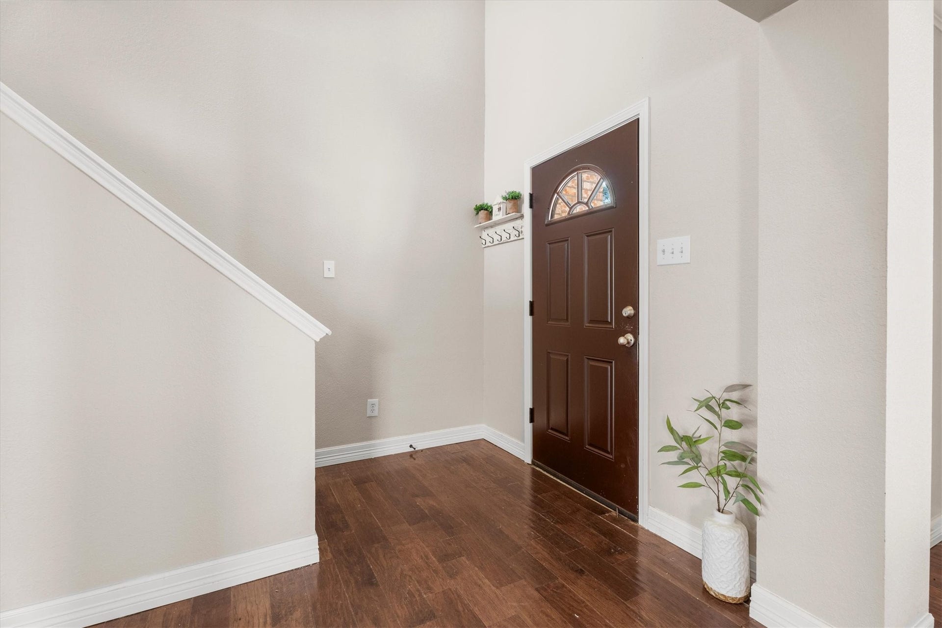 5918 Stirring Winds Lane, Houston, TX 77086 Step inside to a bright foyer featuring soaring ceilings, rich wood flooring, and an open, airy feel.