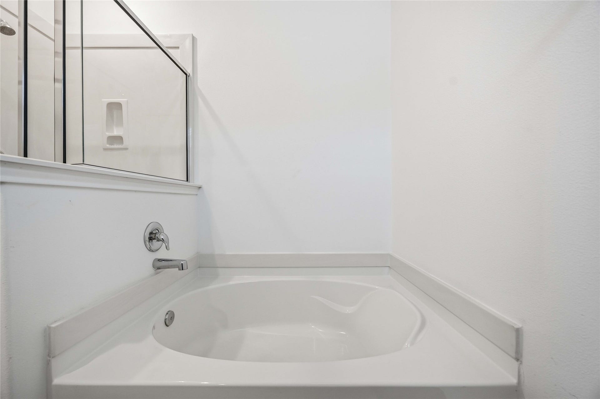 Soaking tub beside the separate shower.