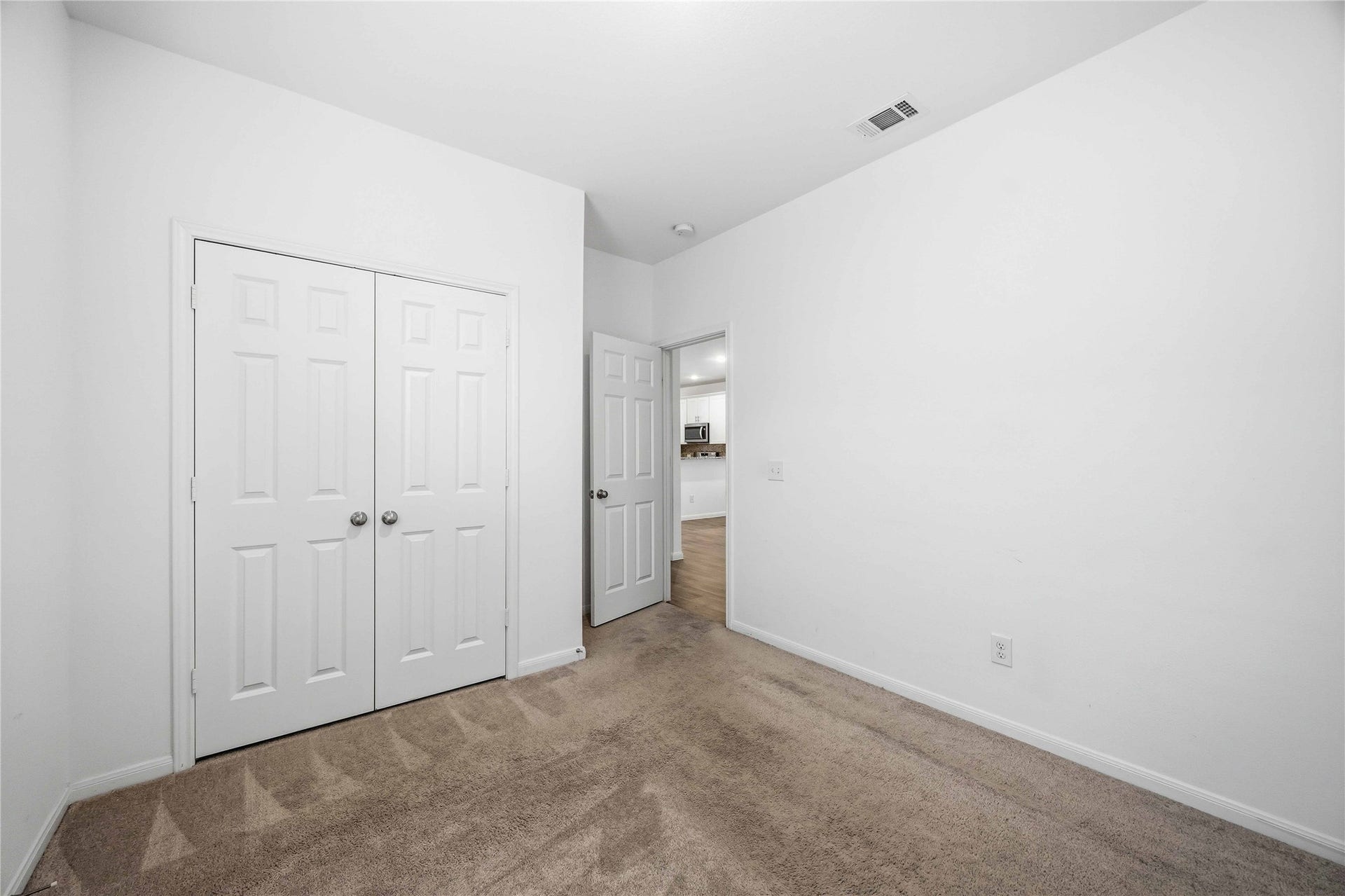 Secondary bedroom featuring a double-door closet.