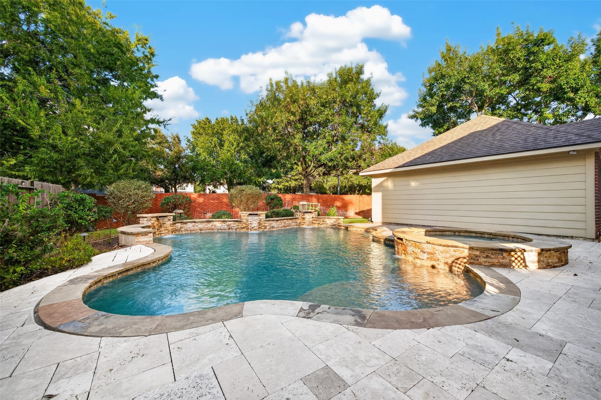 7707 Stone Arbor Drive, Sugar Land, TX 77479 ROOM TO RELAX, ENTERTAIN & PLAY! Expansive Travertine decking surrounds the pool & spa, providing plenty of space for lounge chairs, outdoor furniture & gatherings with friends. And there's still grassy lawn space behind the pool & garage for your four-legged friends to run and play! Whether enjoying a quiet afternoon in the sunshine or hosting a weekend pool party, this backyard offers something for everyone.