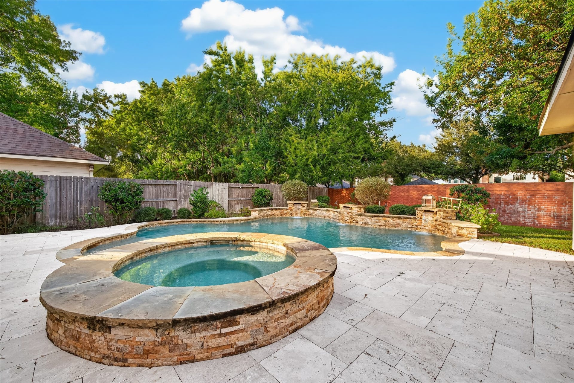 7707 Stone Arbor Drive, Sugar Land, TX 77479 RELAX, UNWIND & STAY AWHILE! Imagine sinking into the heated spa after a long day, listening to the gentle sound of cascading waterfalls and enjoying the peaceful backyard surroundings. The beautiful stonework, curved pool design & lush landscaping create a private resort-like atmosphere right at home.