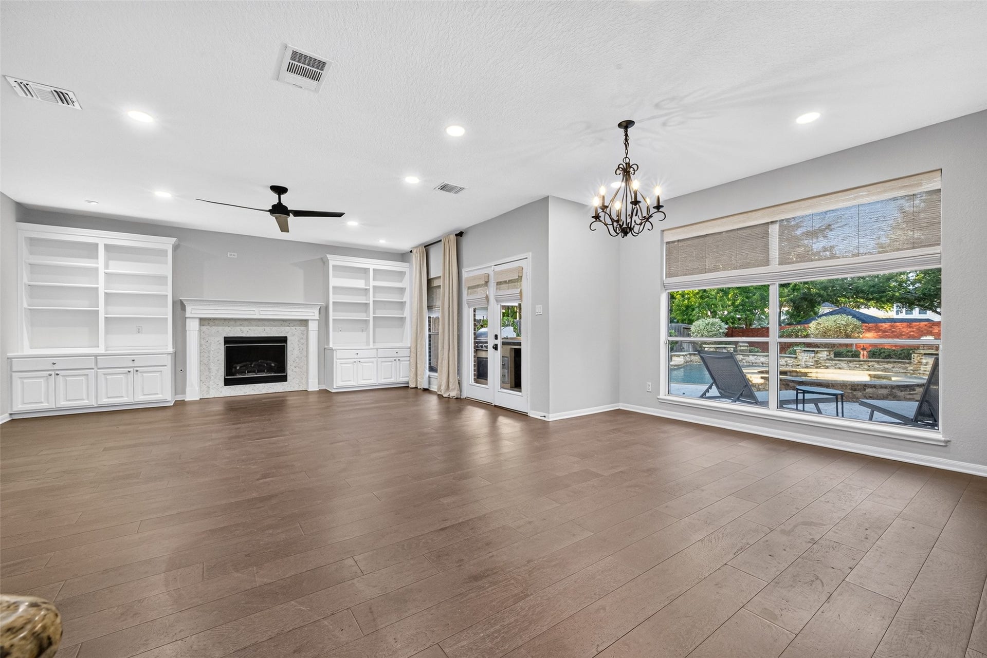 7707 Stone Arbor Drive, Sugar Land, TX 77479 CONNECTED SPACES FOR EVERYDAY LIVING! This wonderful view illustrates how seamlessly the spacious Family Room & adjoining Breakfast Room come together. With no walls separating the two areas, conversation flows naturally from one space to the next. Whether you're relaxing by the fireplace, enjoying a meal or visiting with friends, the open arrangement allows everyone to enjoy different activities while still feeling connected. And with those beautiful backyard views, the pool is never far from sight.