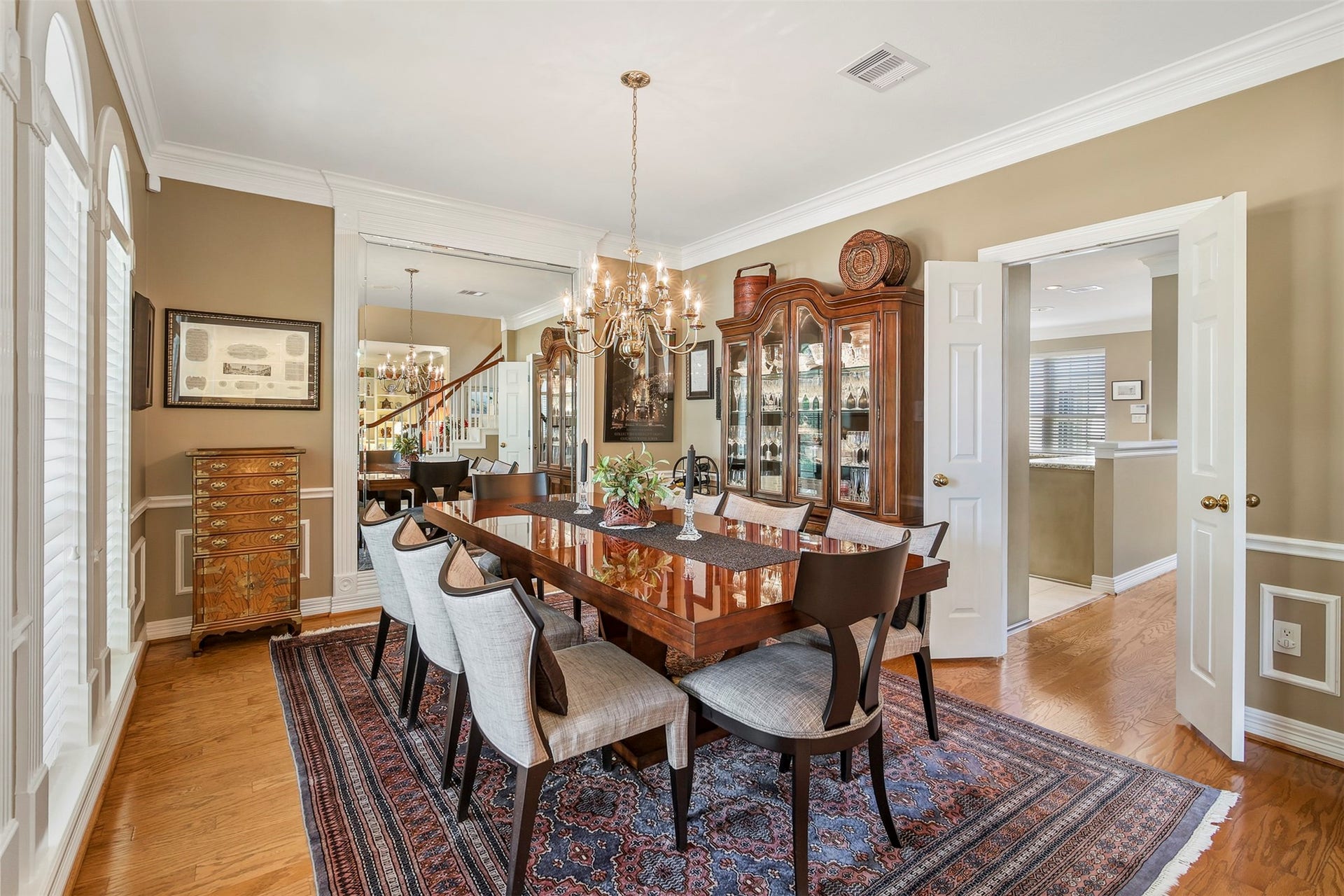 1414 Forest Bend, Sugar Land, TX 77479 Another view of the dining room with double doors leading to the kitchen and floor to ceiling mirror.