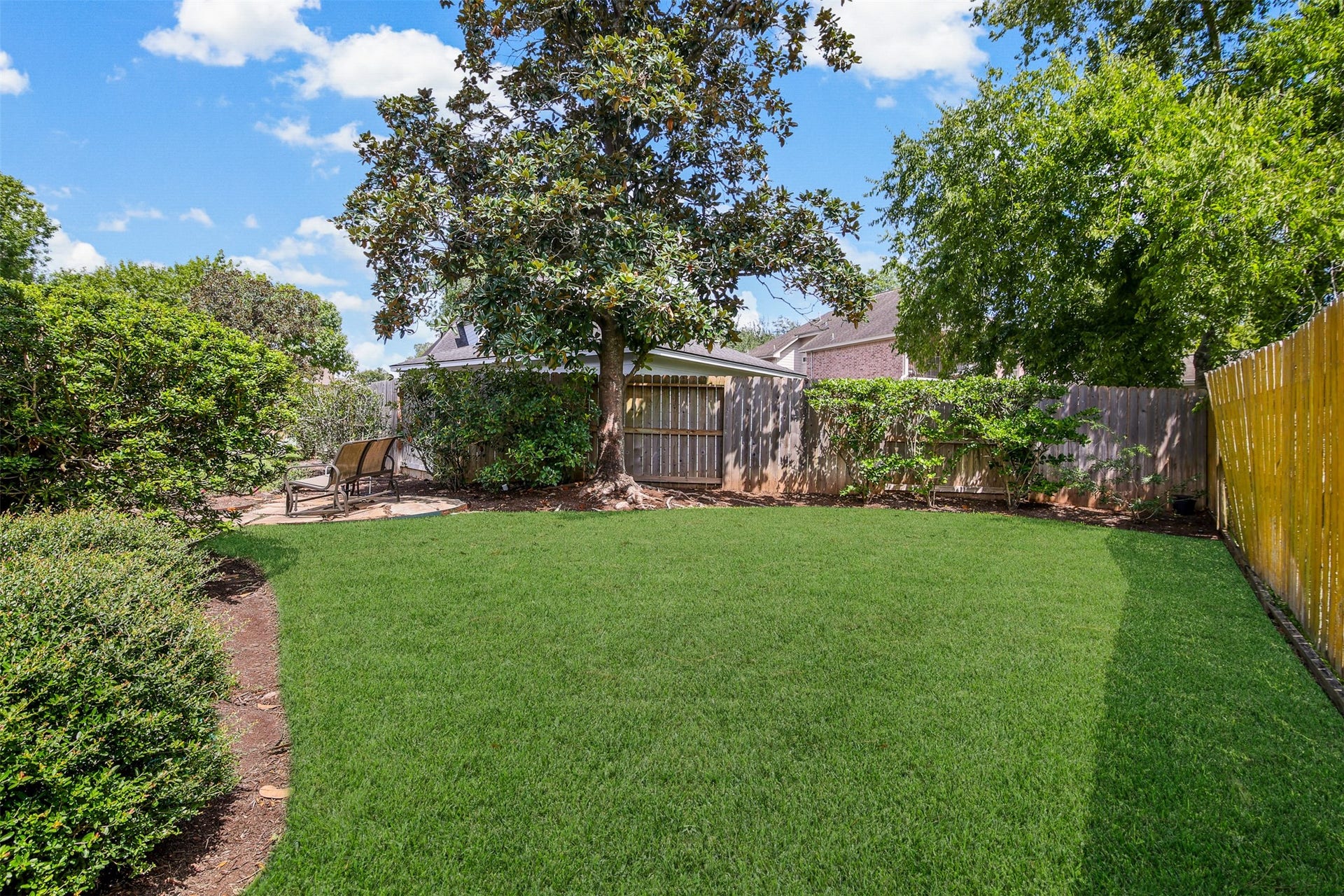 1414 Forest Bend, Sugar Land, TX 77479 Another view of the backyard with plenty of green space for the kids and pets to play. *Grass has been virtually enhanced*