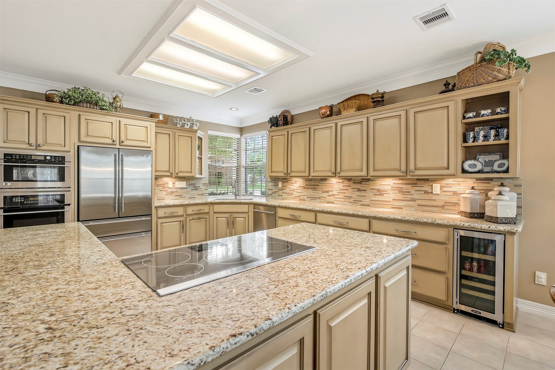 1414 Forest Bend, Sugar Land, TX 77479 The spacious updated kitchen is ready for its next chef. The kitchen features granite countertops with tile backsplash. There are custom cabinets for plenty of storage space to include pots and pans drawers as well as under cabinet lighting.