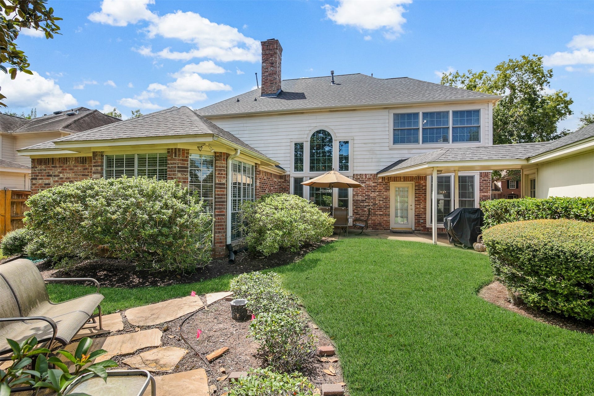1414 Forest Bend, Sugar Land, TX 77479 View of the back elevation of the home. *Grass has been virtually enhanced*