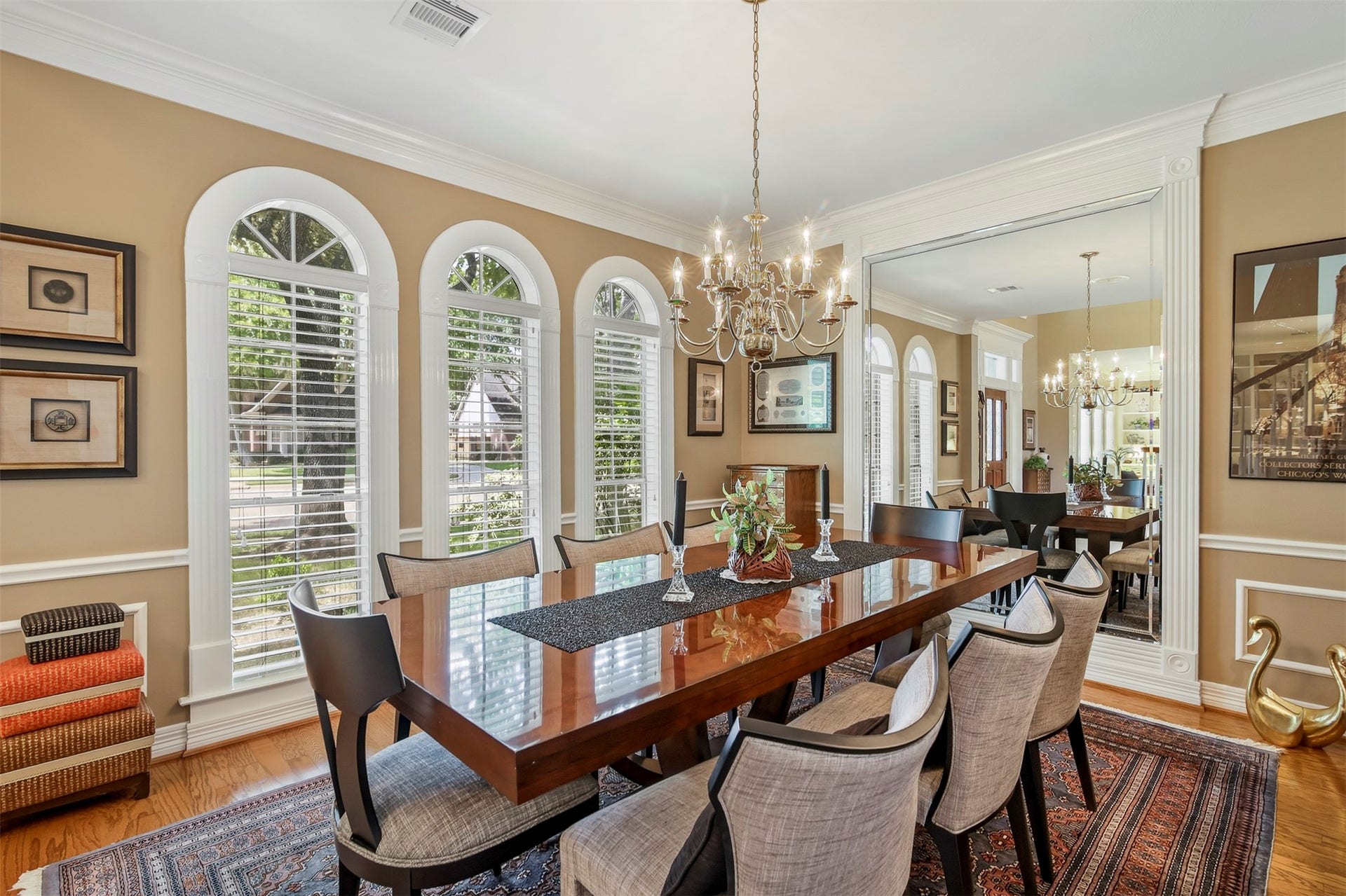 1414 Forest Bend, Sugar Land, TX 77479 Spacious dining room features wood floors, decorative trim work throughout to include wainscotting, crown molding and arched floor to ceiling windows.