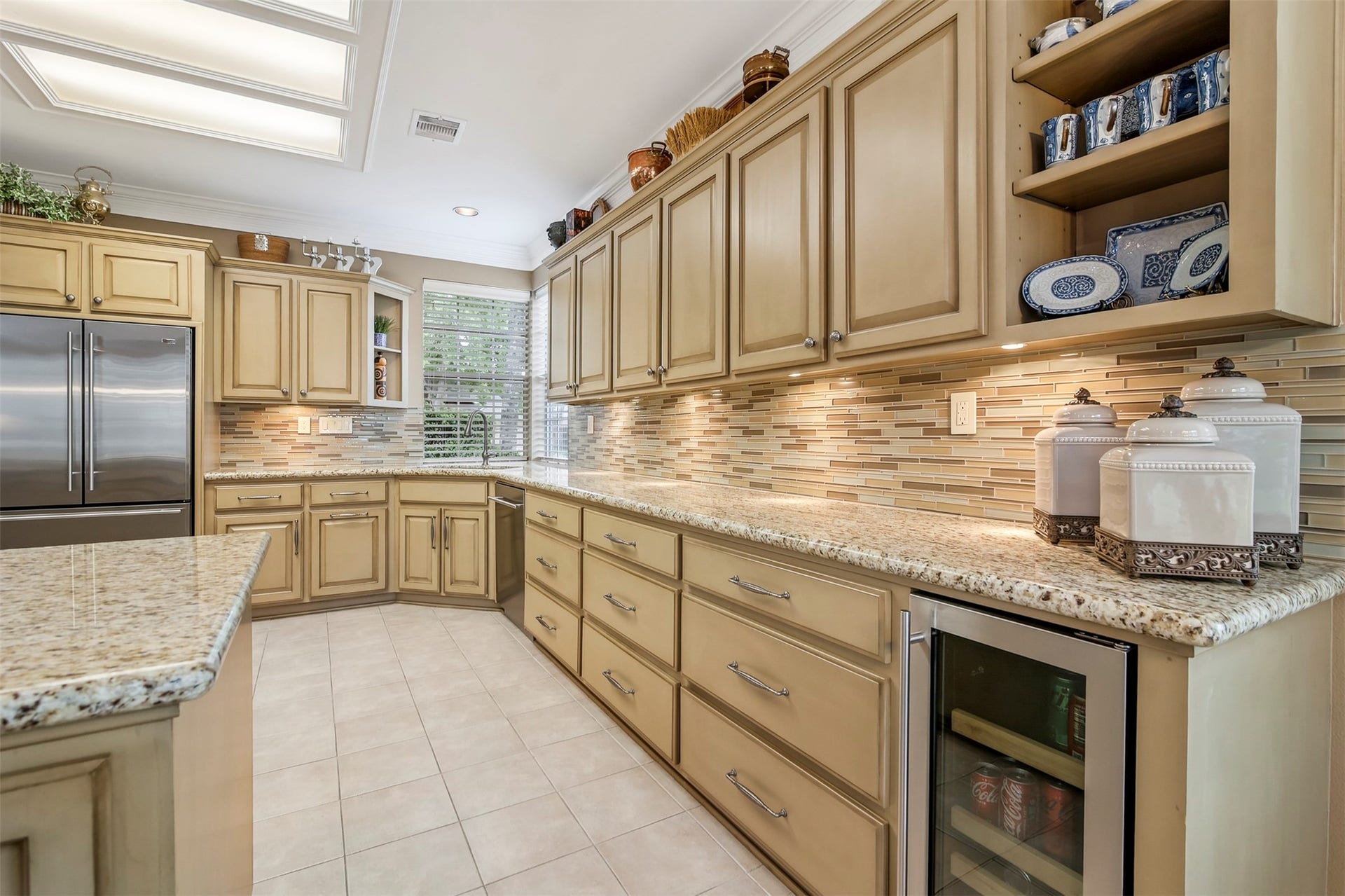 1414 Forest Bend Drive, Sugar Land, TX 77479 Another view of the kitchen with exposed custom shelving at the ends of the cabinets.