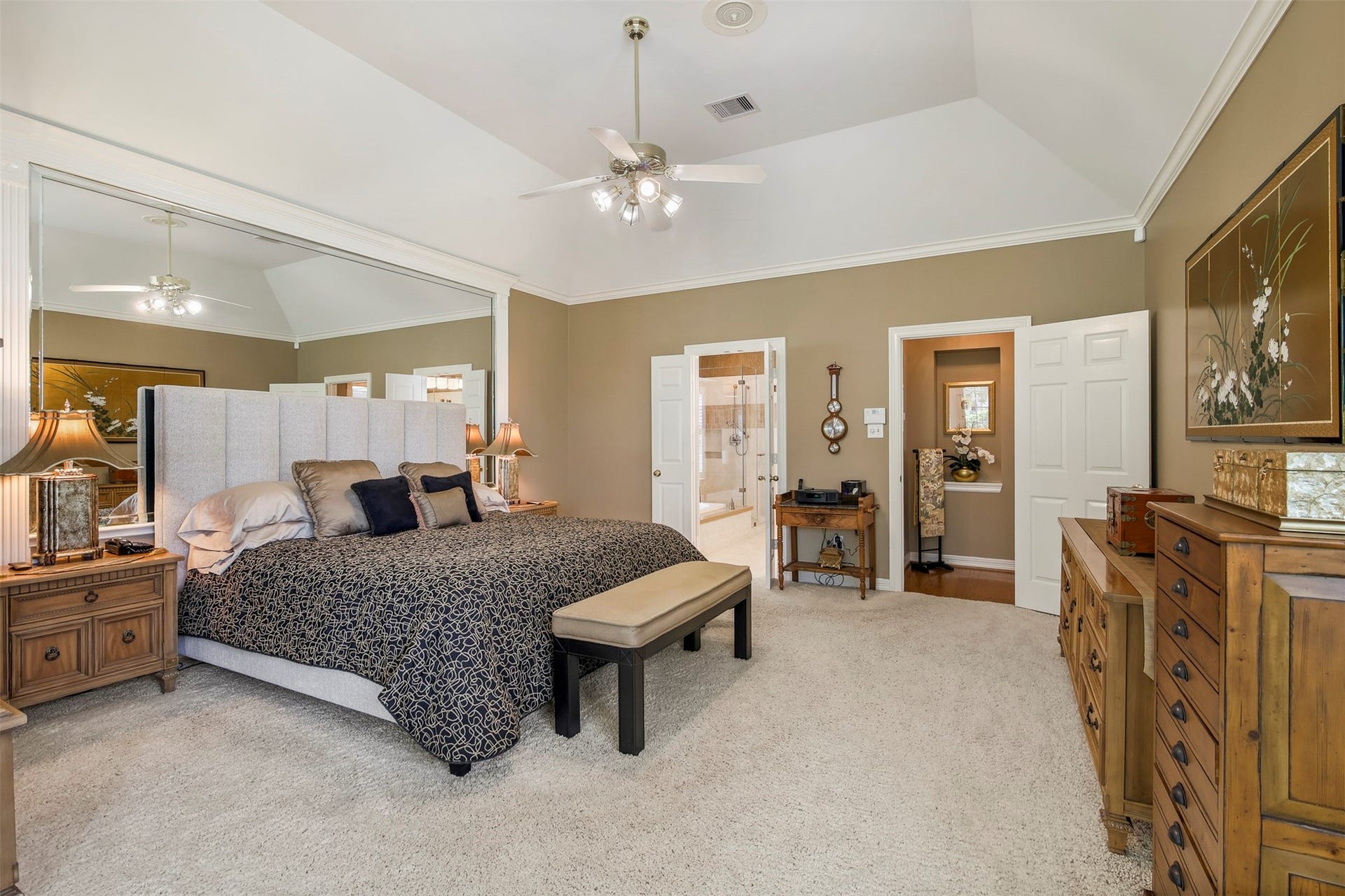1414 Forest Bend, Sugar Land, TX 77479 Another view of the primary bedroom with crown molding and large mirrored wall.