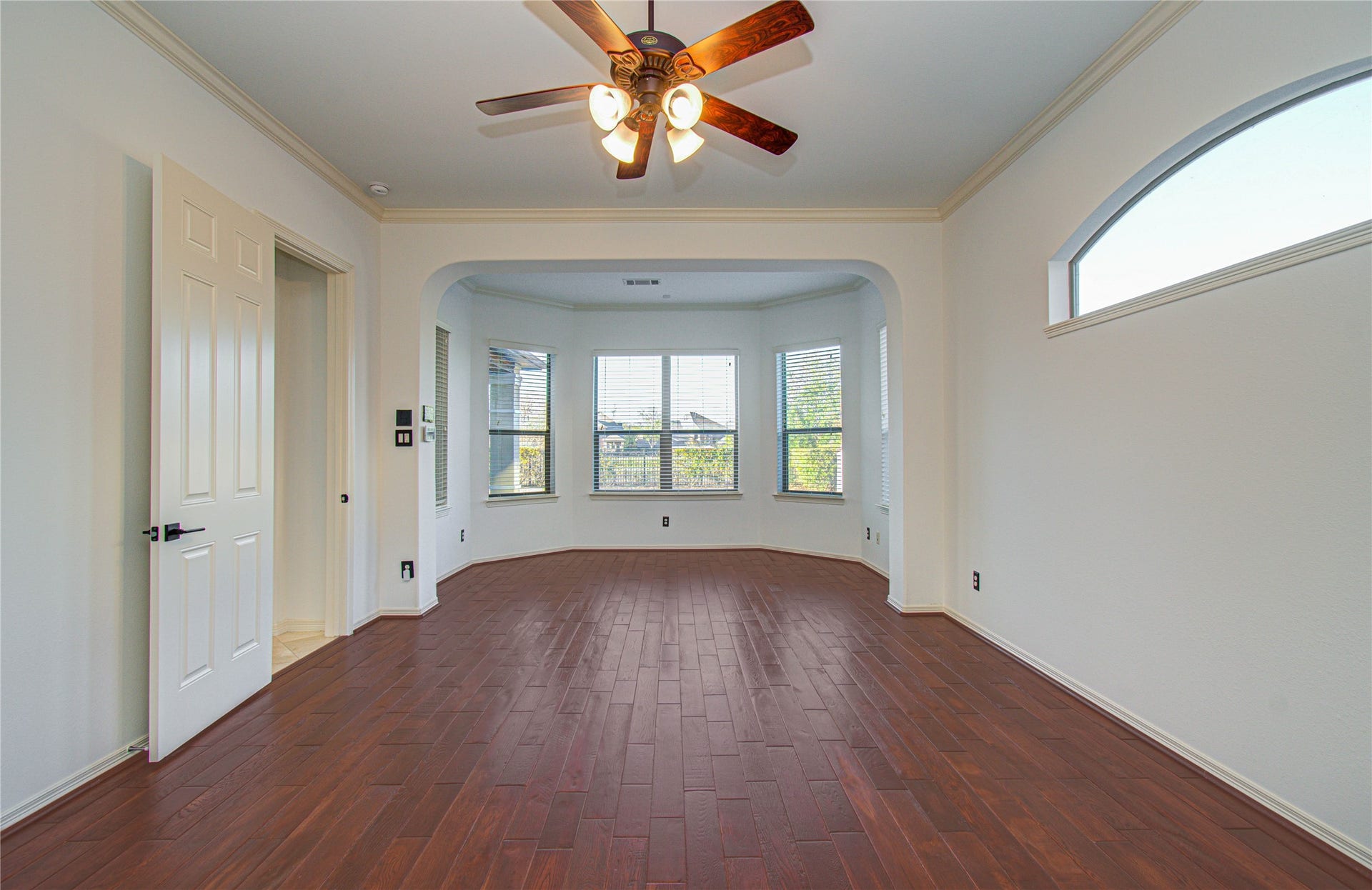 Spacious primary bedroom featuring a charming nook with abundant natural light.