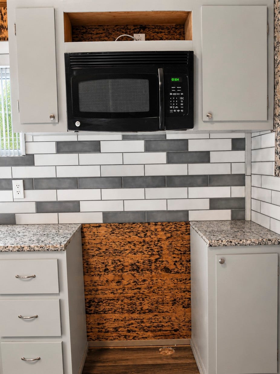 Addition kitchen nook featuring a modern black microwave.