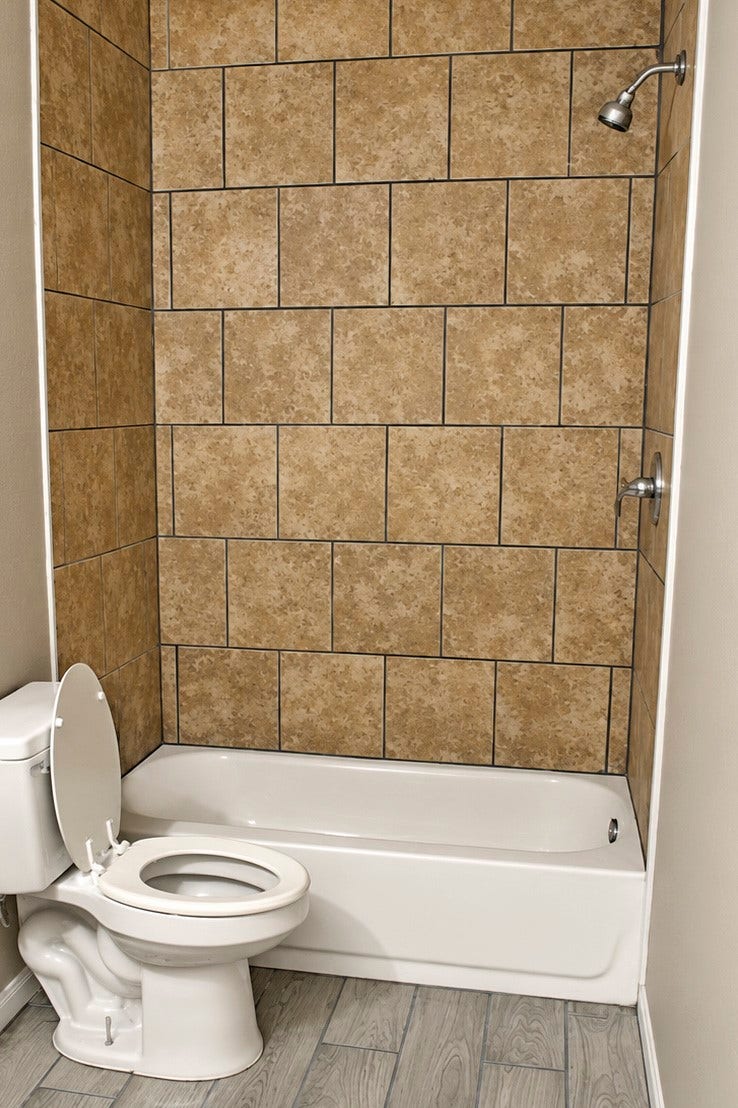 Bathroom features a tiled shower and tub combination, complemented by neutral-toned walls.