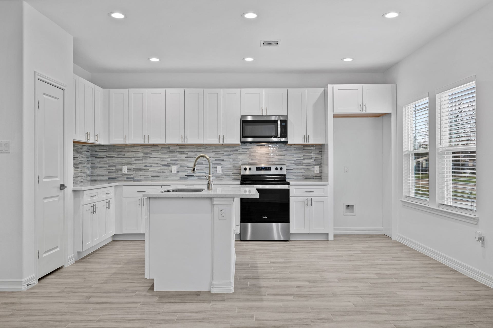 The dishwasher is conveniently located underneath the island opposite the very spacious pantry.