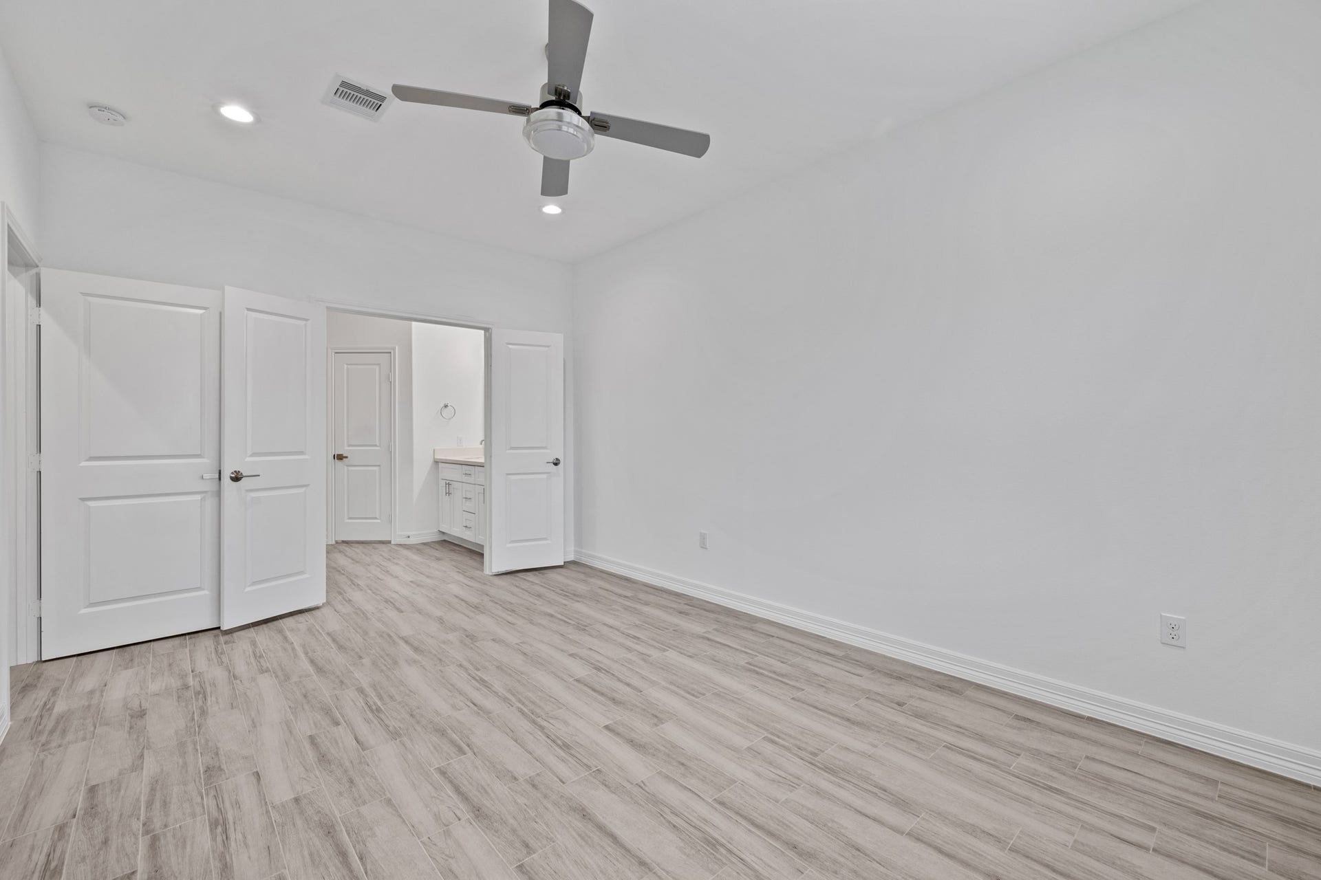 The double doors leading to the primary bathroom offer additional privacy for the early riser or the nighthawk.