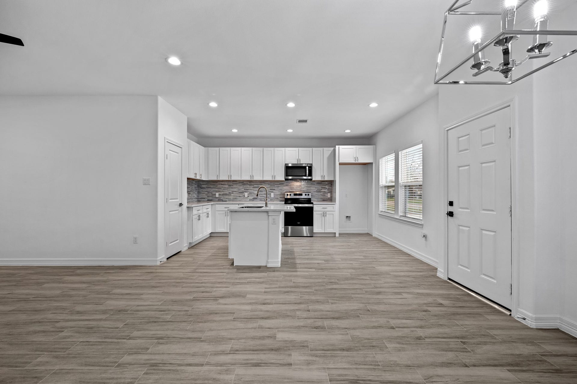 This view gives you a peek at additional placement opportunities in the kitchen, including barstools and/or a cute bistro table or high-boy. In addition, you can see how the cook is never absent from the fun taking place in the living room!