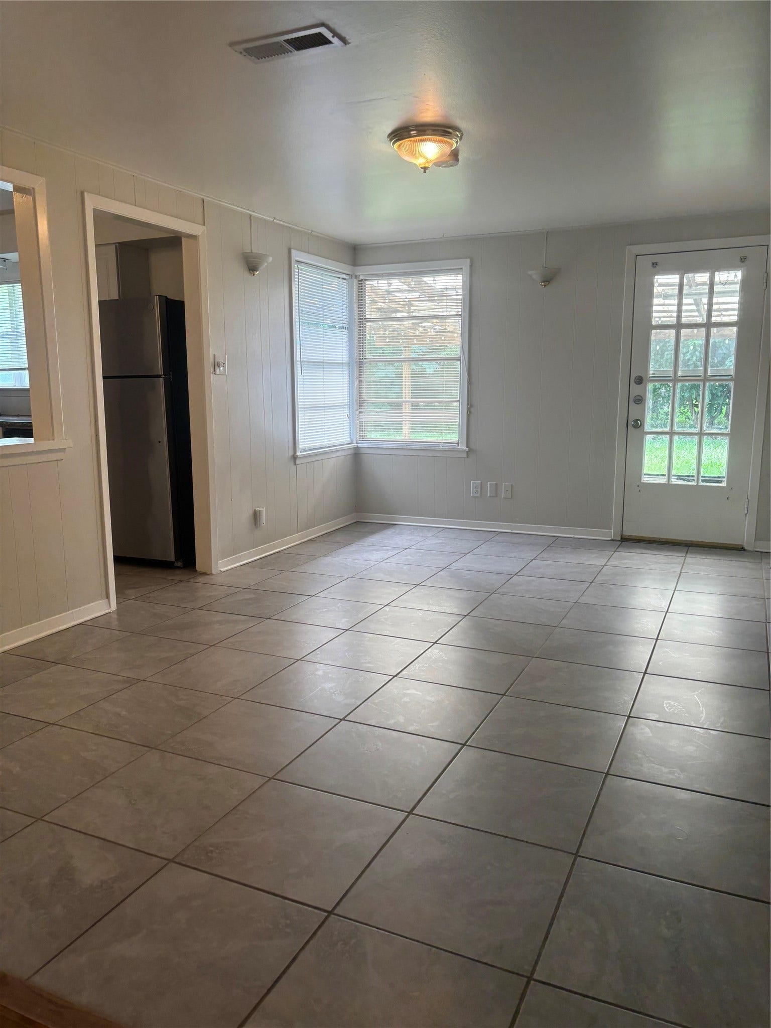 4713 Saxon Street, Bellaire, TX 77401 Dining area, large open area with tile flooring and adjoins living room, kitchen and den area, opens to back patio/yard