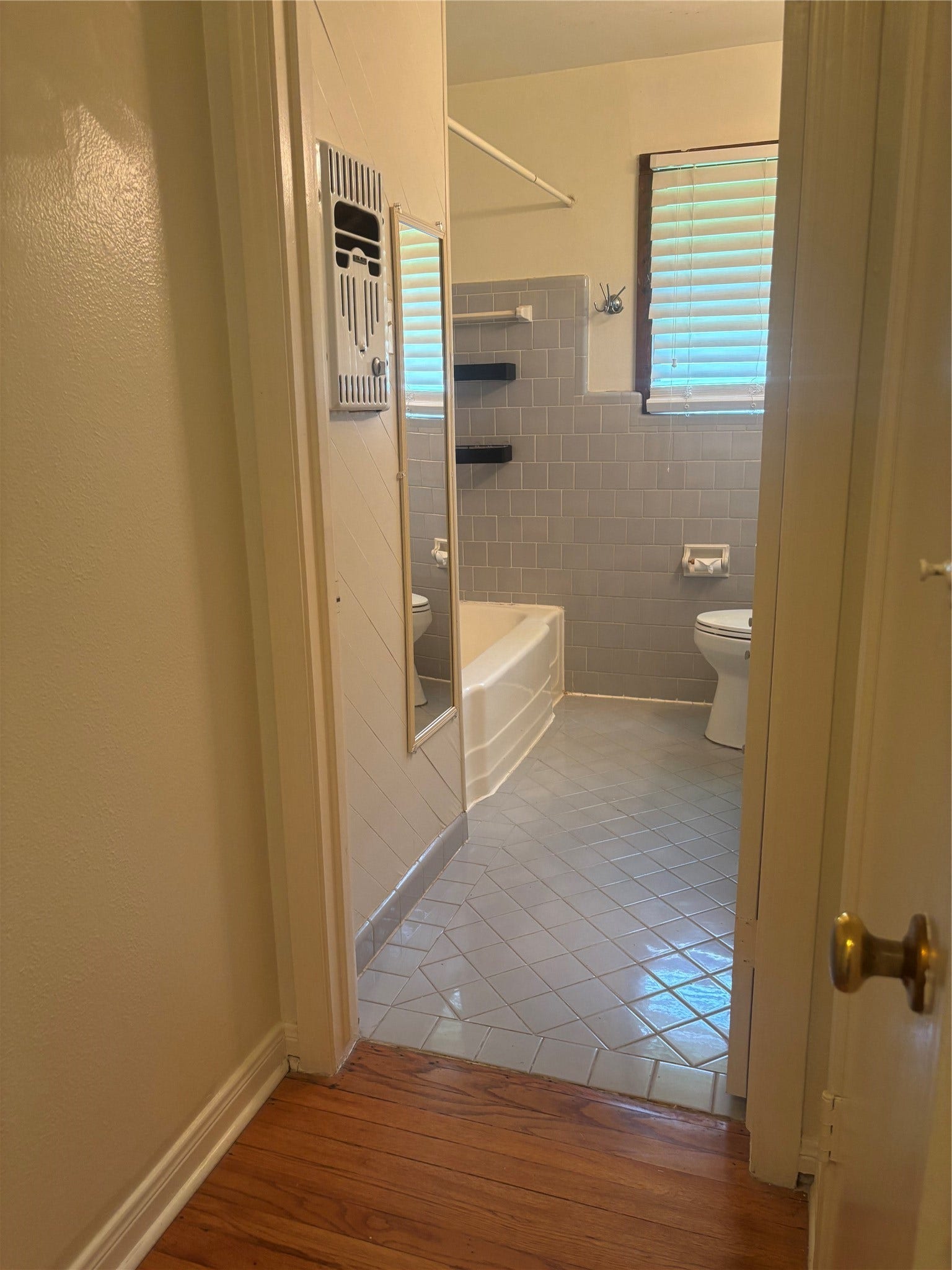 4713 Saxon Street, Bellaire, TX 77401 Primary (Hall) bathroom, tub and shower combine, gray tile