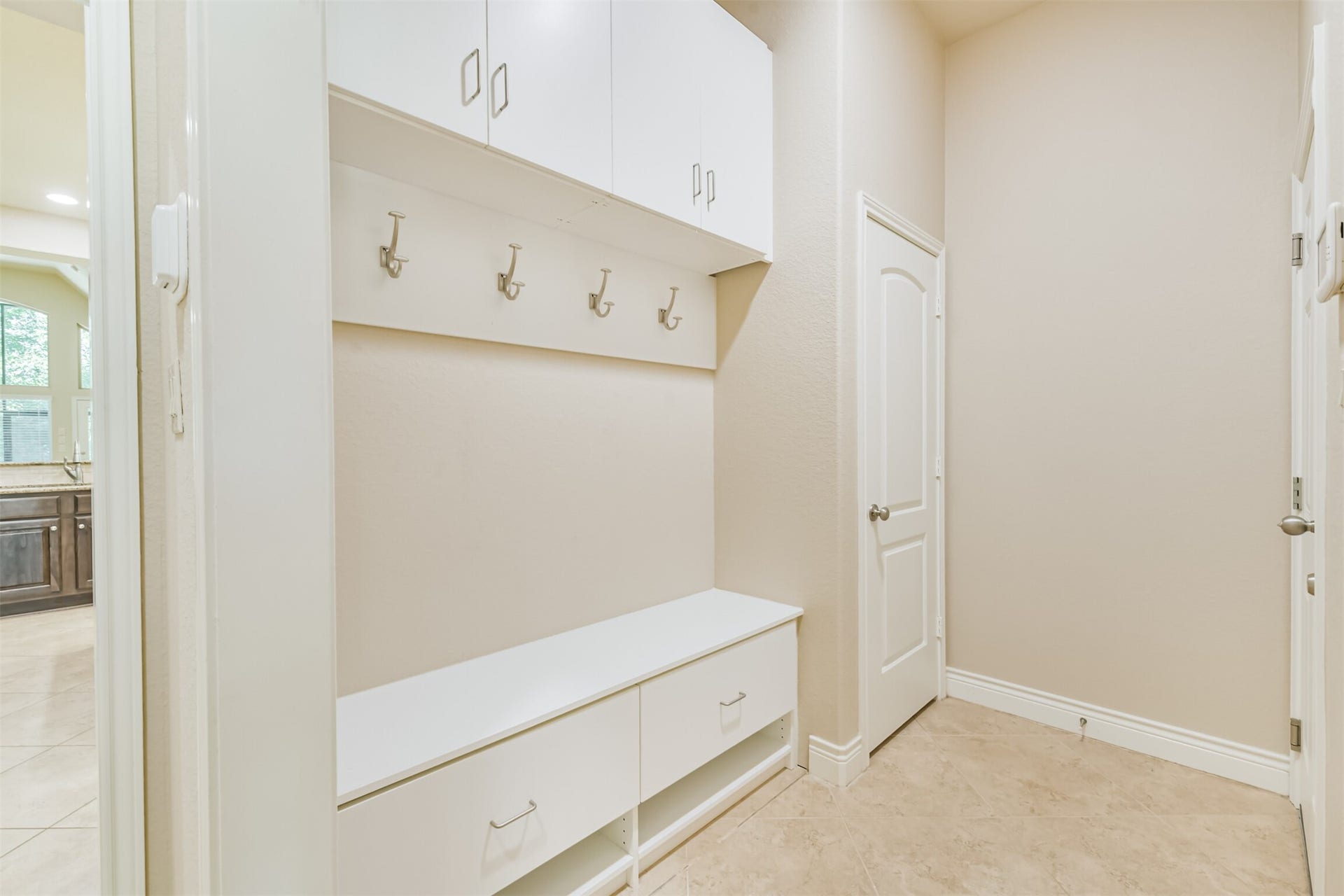 1735 Wickham Reach Drive, Spring, TX 77386 Convenient storage area with built-in cabinetry and a coat rack for organized everyday storage.