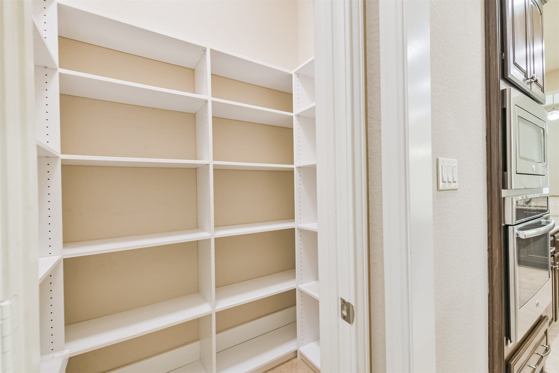 1735 Wickham Reach Drive, Spring, TX 77386 Spacious pantry with built-in shelving for organized food and kitchen storage.