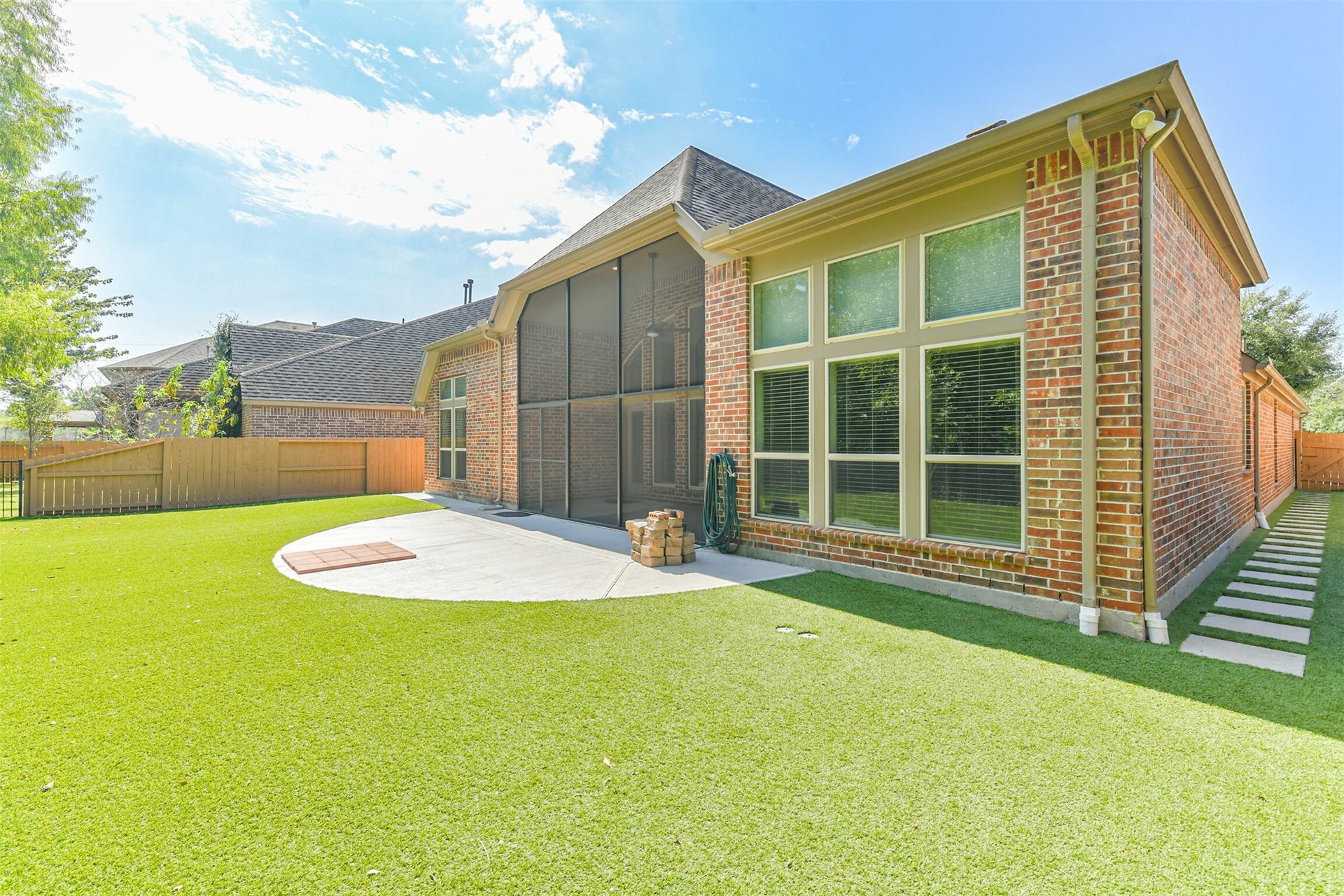 1735 Wickham Reach Drive, Spring, TX 77386 Rear exterior view highlighting the screened patio and spacious yard.