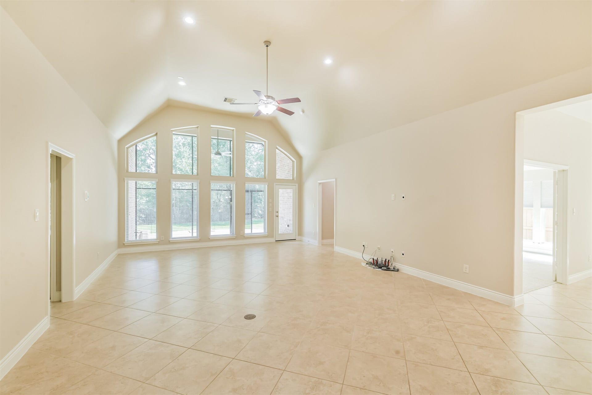 1735 Wickham Reach Drive, Spring, TX 77386 Spacious living area with tall windows and an open, airy feel.