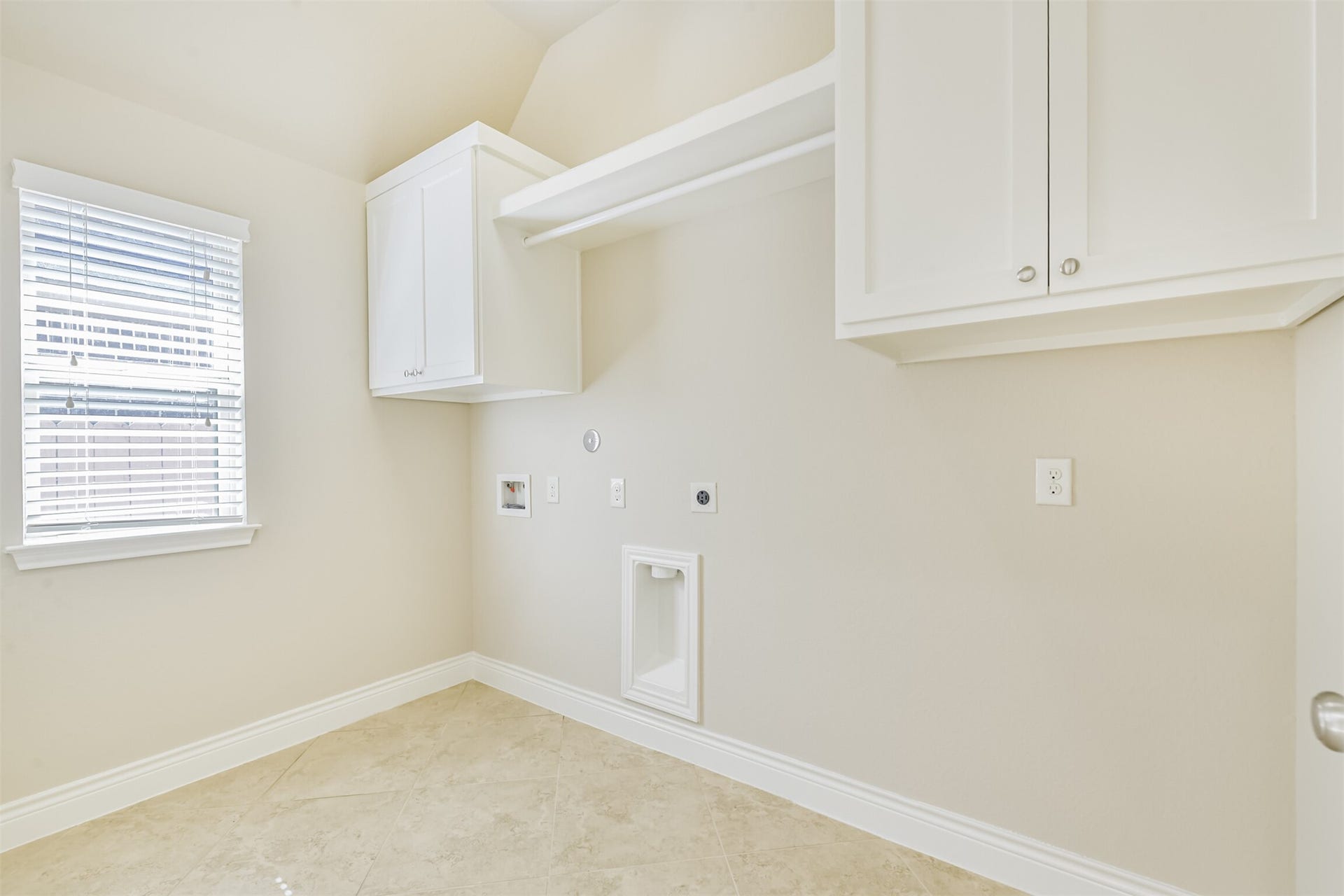 1735 Wickham Reach Drive, Spring, TX 77386 Utility room with built-in cabinetry and convenient workspace.
