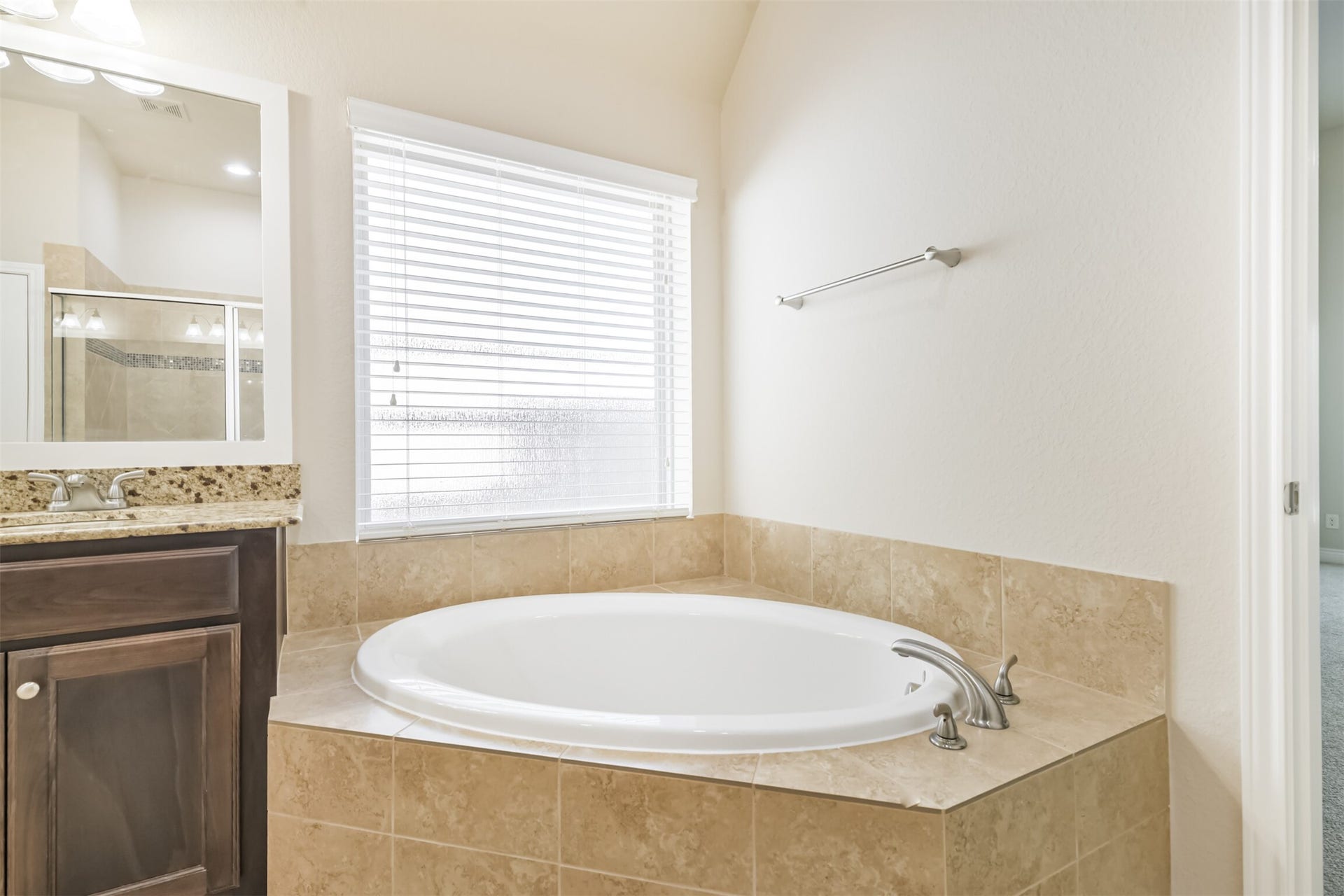 1735 Wickham Reach Drive, Spring, TX 77386 Primary bathroom with a soaking tub and natural light.
