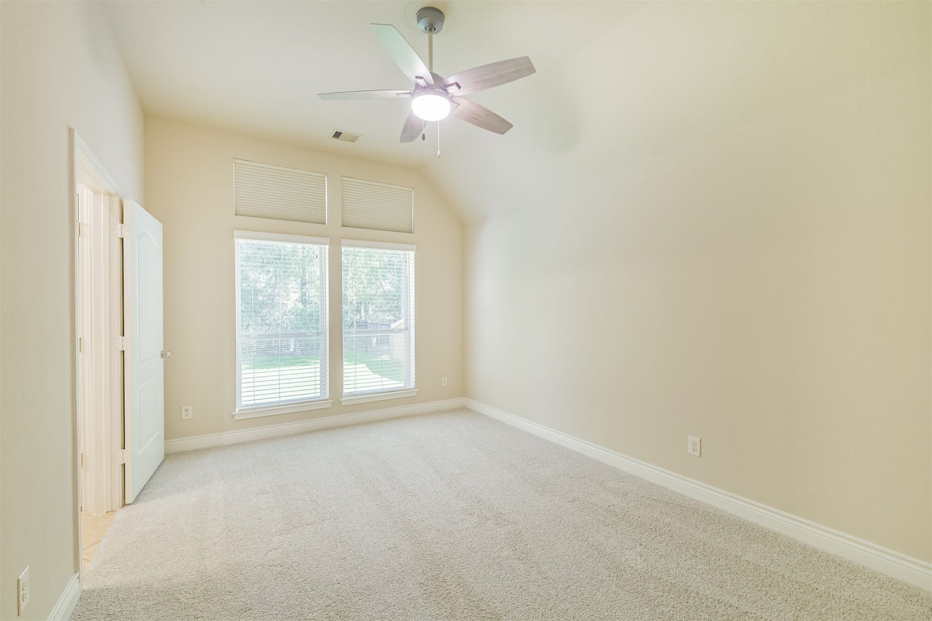 1735 Wickham Reach Drive, Spring, TX 77386 Bright secondary bedroom with large windows and natural light.
