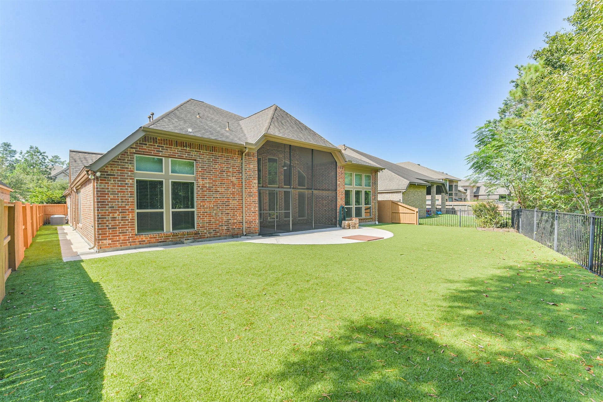 1735 Wickham Reach Drive, Spring, TX 77386 Rear exterior view showcasing the home and expansive backyard.