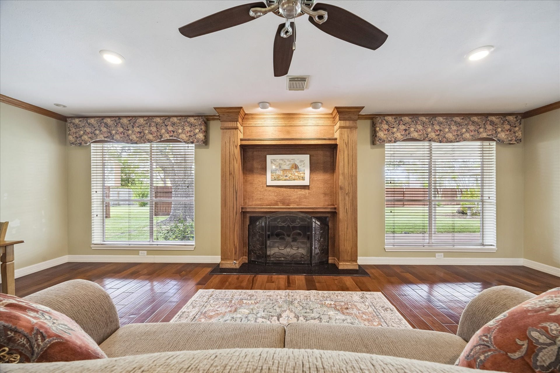 1306 Forest Hollow Drive, Missouri City, TX 77459 The living room offers a view of the lovely backyard through windows that flank each side of the gas fireplace.
