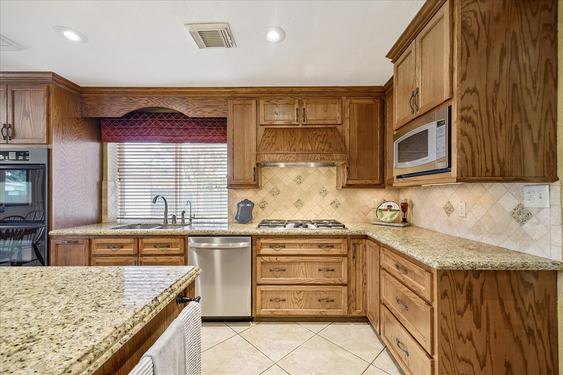 1306 Forest Hollow Drive, Missouri City, TX 77459 This custom kitchen offers solid wood cabinets, gas cooktop, double ovens and drawers for your cookware.