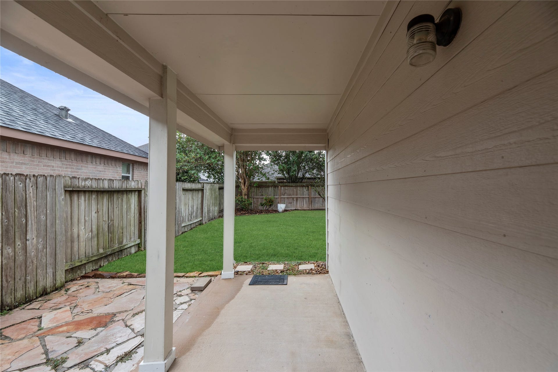 14223 Pinefrost Lane, Cypress, TX 77429 Covered patio and flagstone patio area.