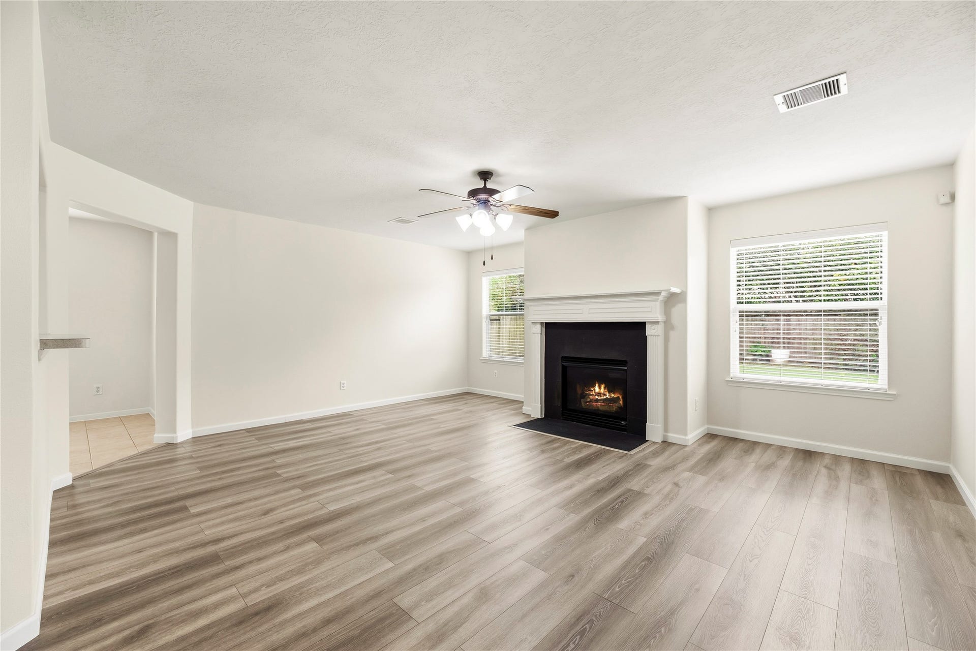 14223 Pinefrost Lane, Cypress, TX 77429 The family room offers LVP flooring and a gas log fireplace.