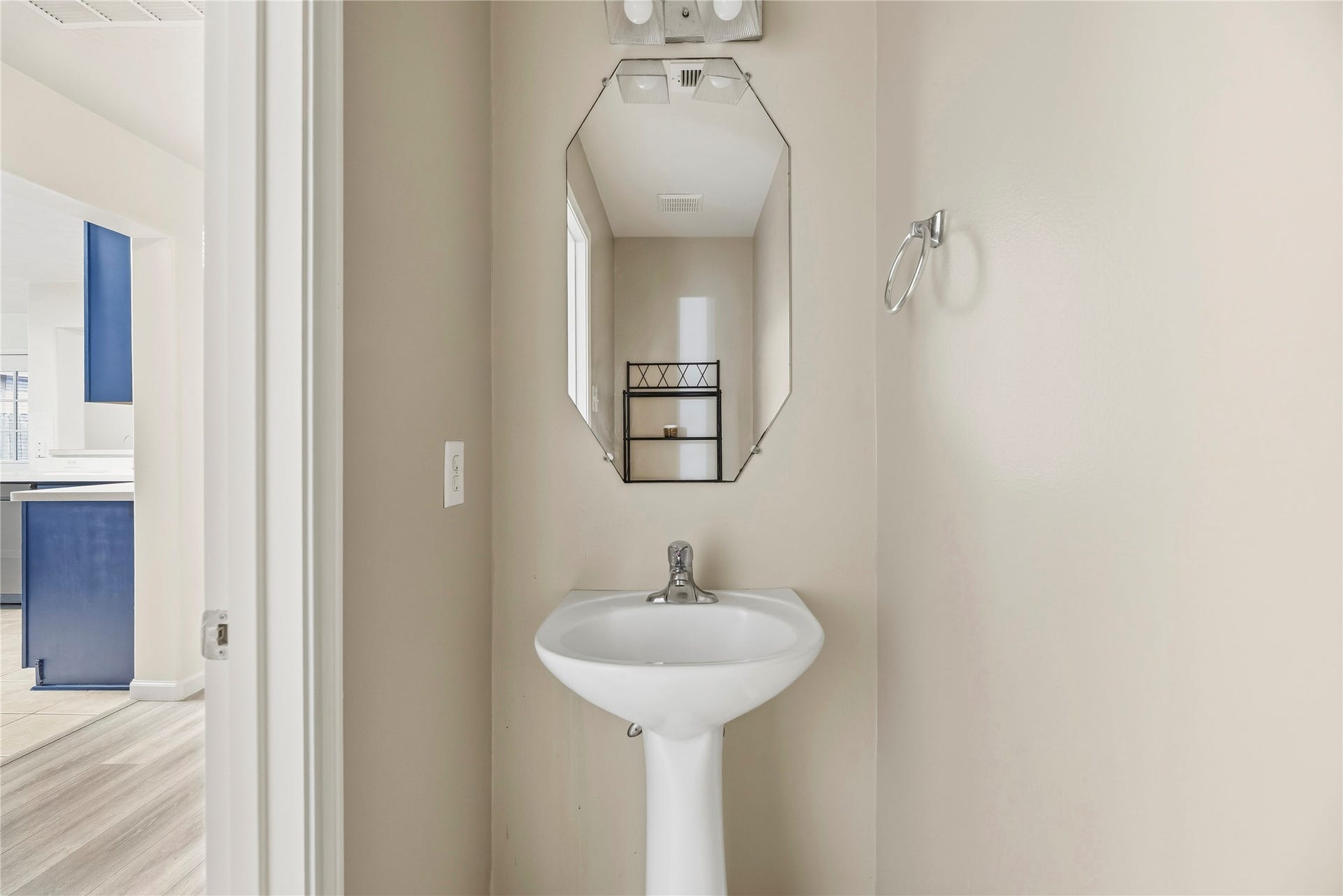 14223 Pinefrost Lane, Cypress, TX 77429 Convenient downstairs half bathroom with a pedestal sink.