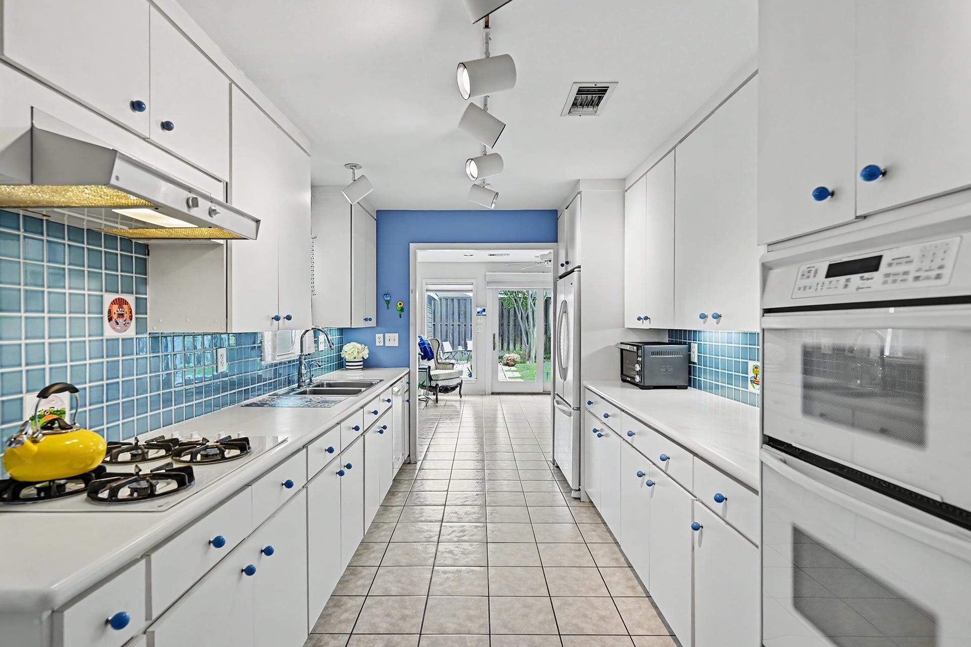 4102 Portsmouth Avenue, Houston, TX 77027 Another view of the kitchen looking toward the family room. Undercabinet lighting and wall microwave/electric oven.