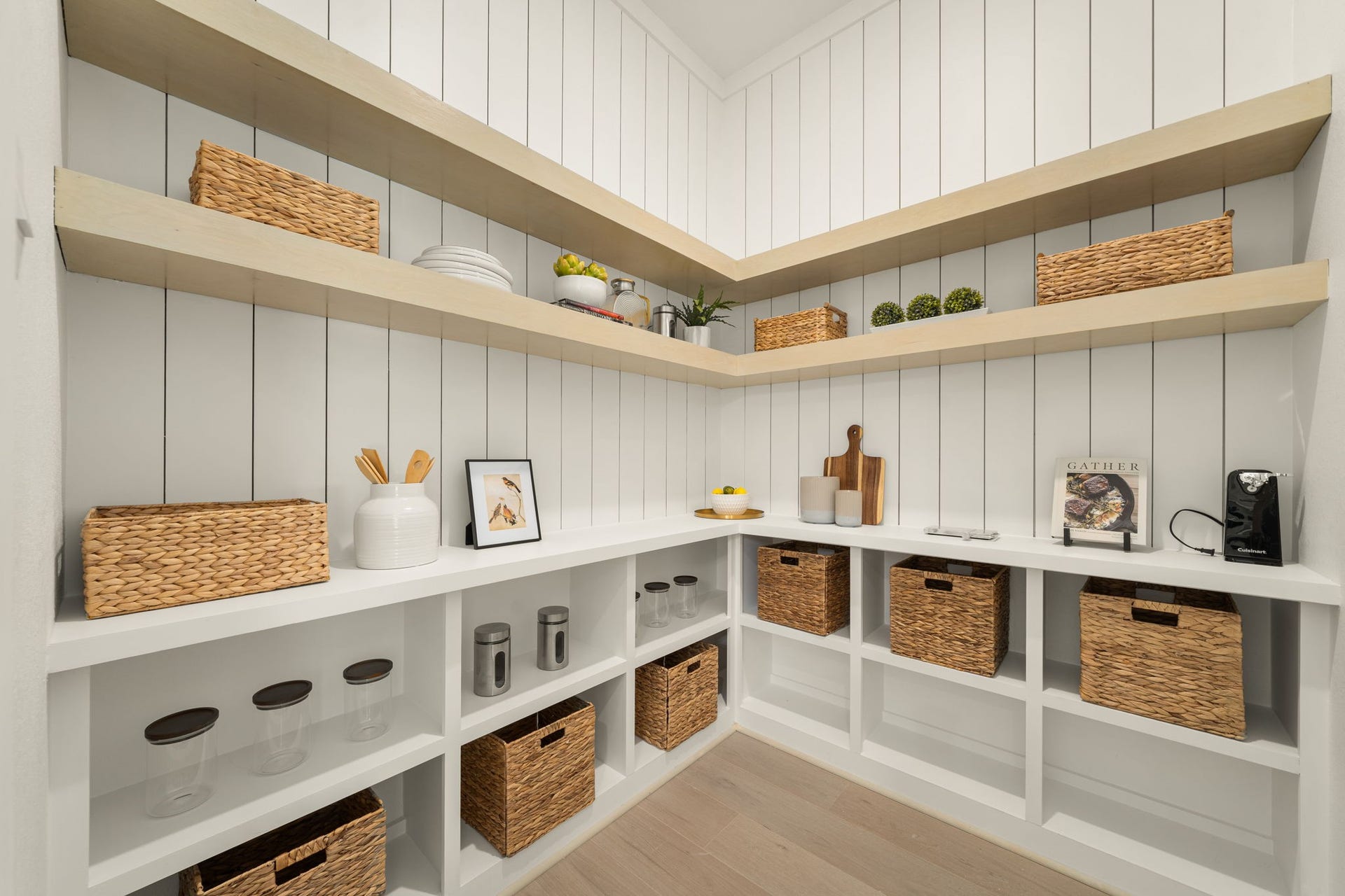 Exceptional walk-in pantry featuring extensive built-in shelving, cabinetry, and thoughtfully designed storage.