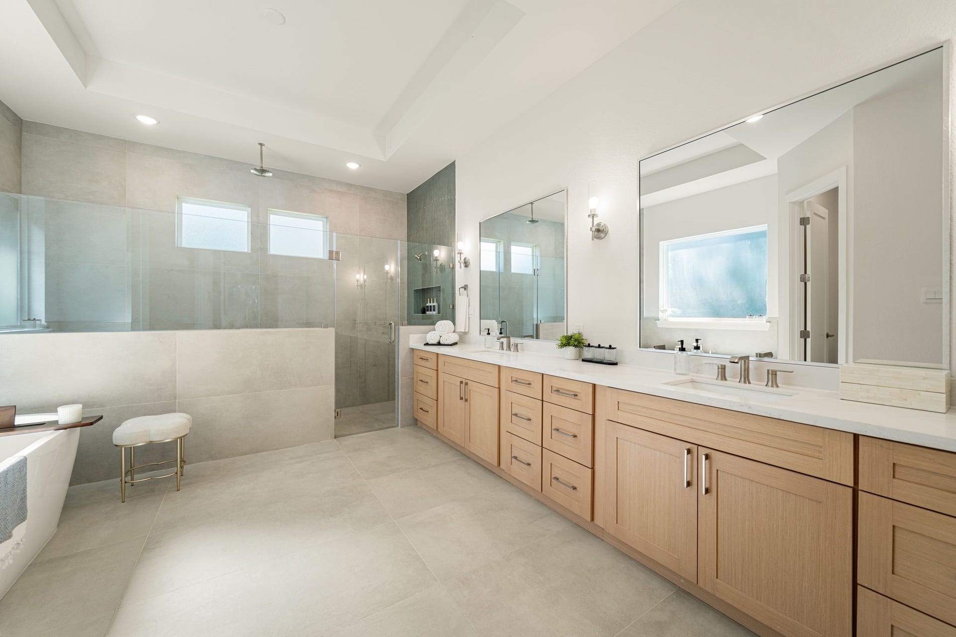 Beautiful primary bathroom with dual sinks, generous countertop space, and a luxurious soaking tub.