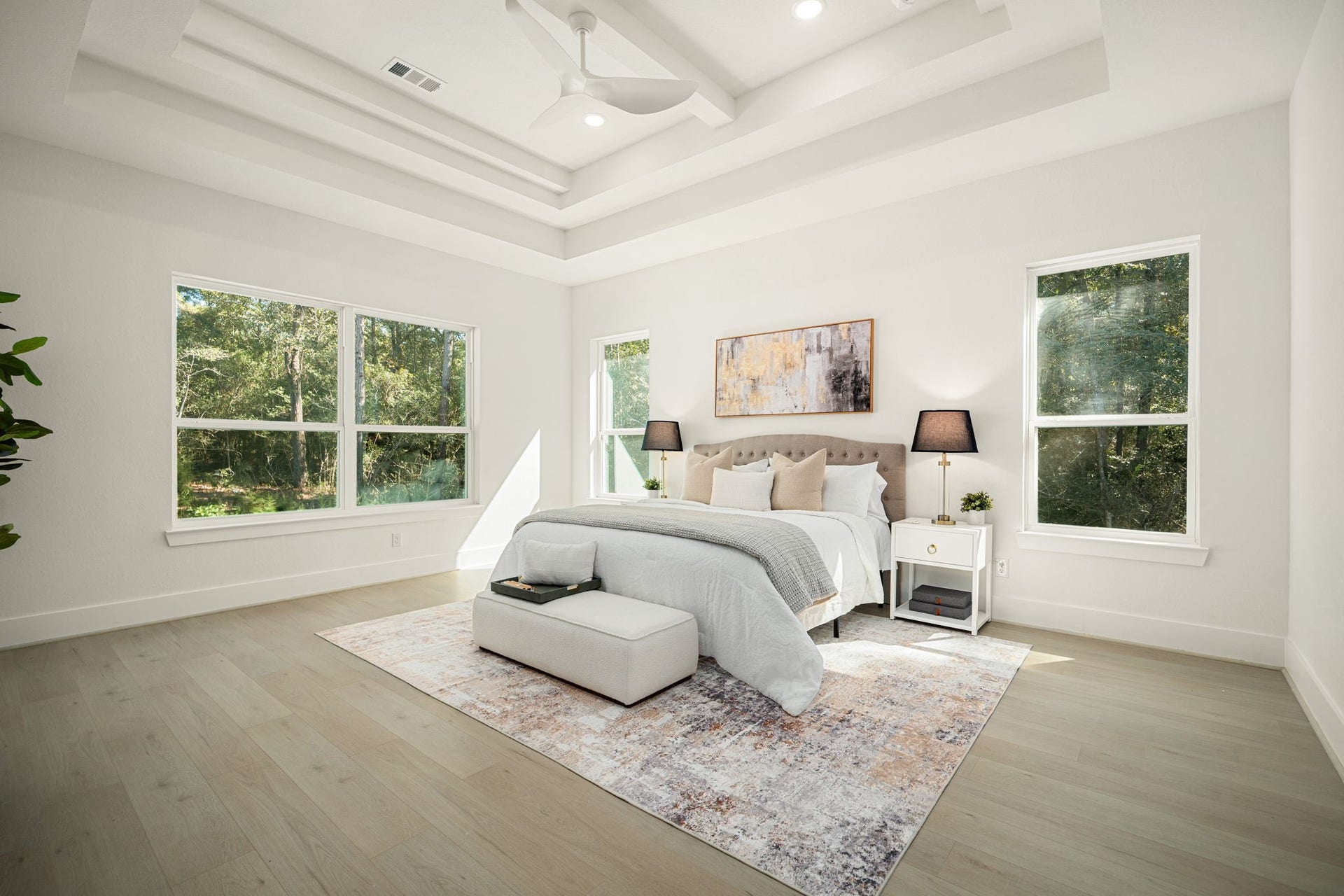 Luxurious primary bedroom featuring elegant ceiling details, generous proportions, and beautiful natural light.