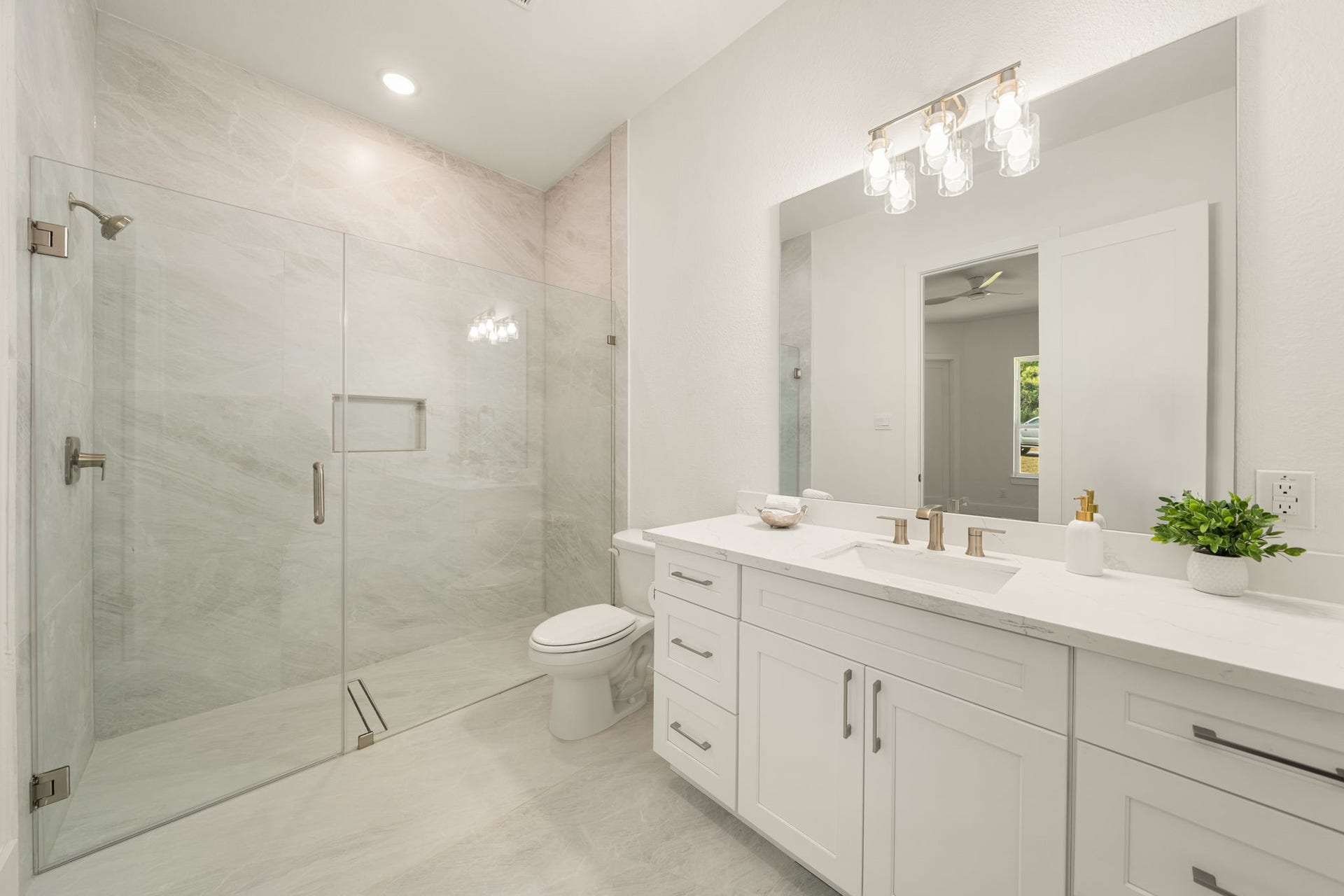 Beautifully appointed secondary bathroom featuring a glass-enclosed shower and contemporary vanity.