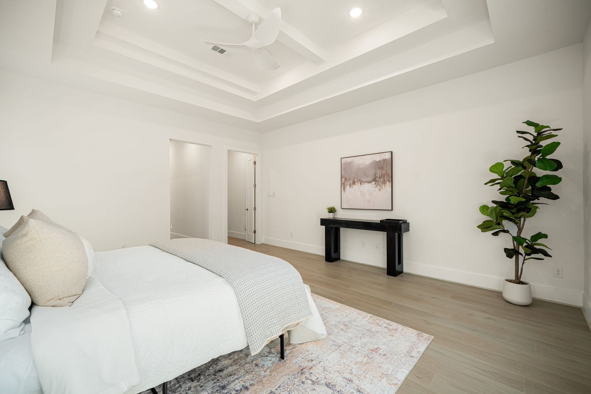 Spacious primary suite showcasing a serene neutral palette and a relaxing, private atmosphere.