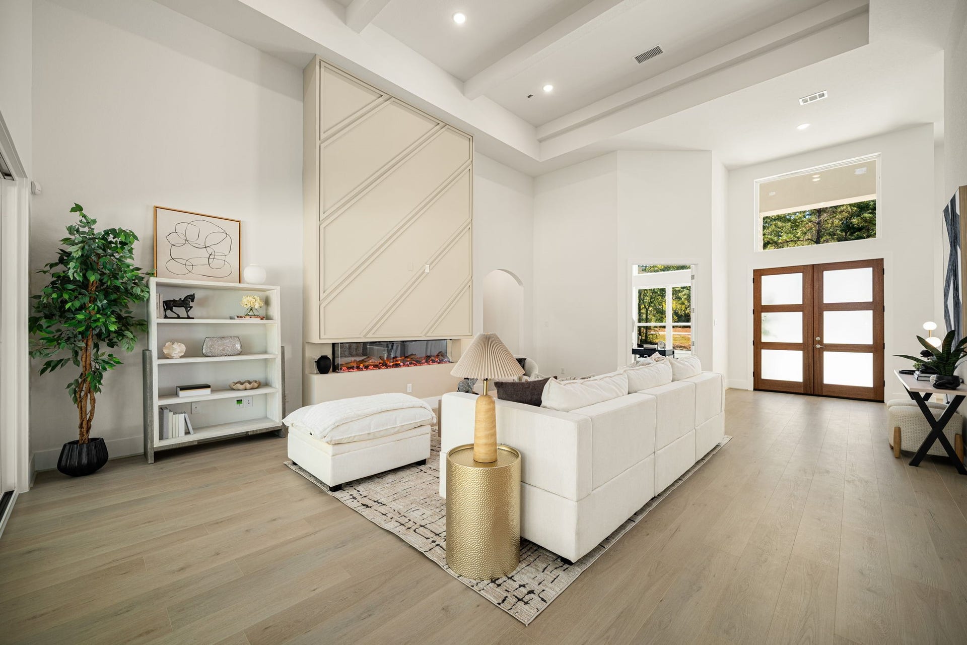 Beautifully designed living area featuring a sophisticated neutral palette, high ceilings, and abundant natural light.