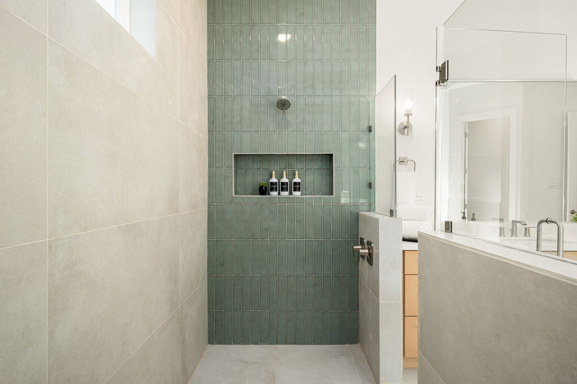 Additional view of the beautifully designed primary shower with a built-in niche and elegant tile selections.