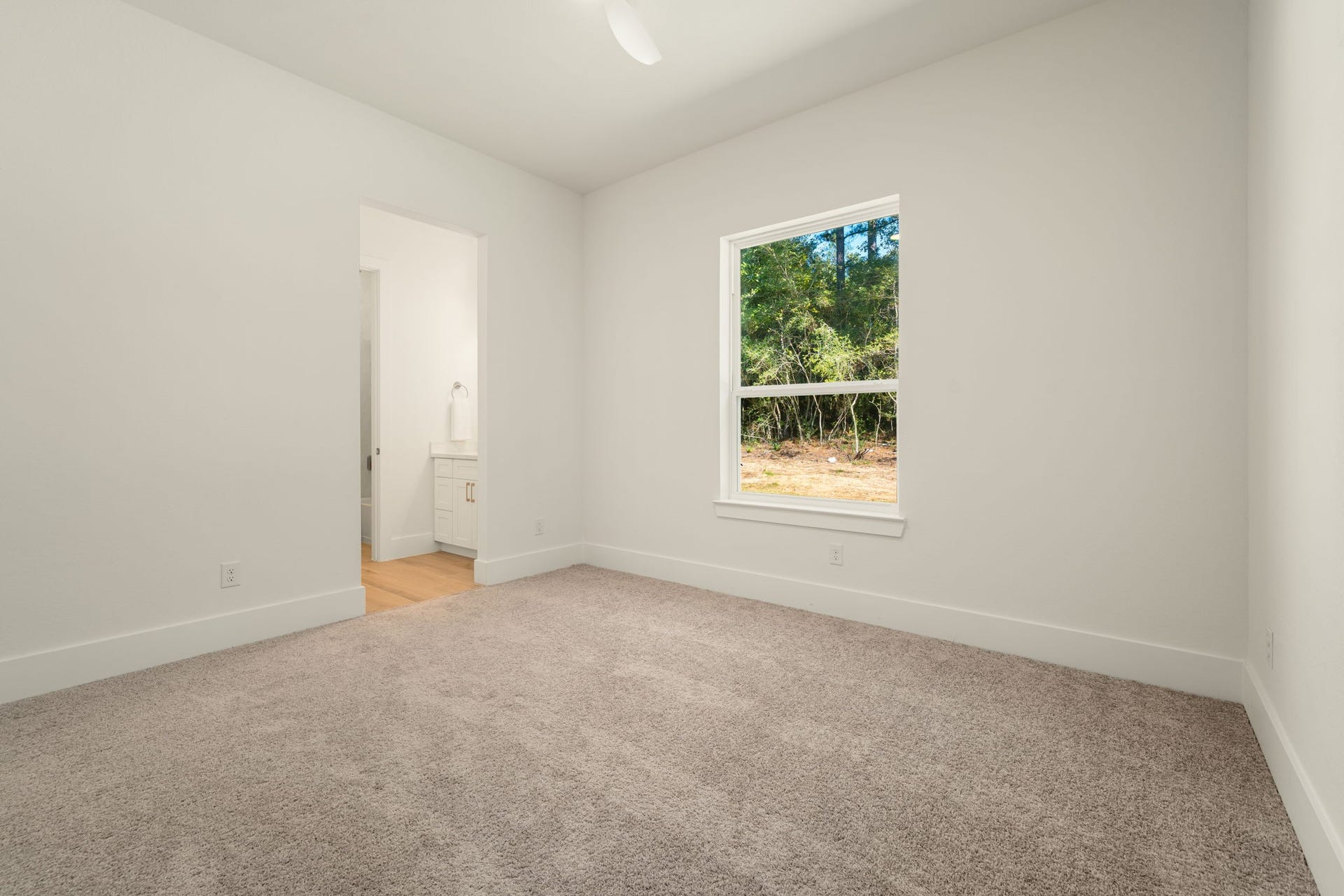 Comfortable secondary bedroom with neutral finishes and plenty of space to personalize.