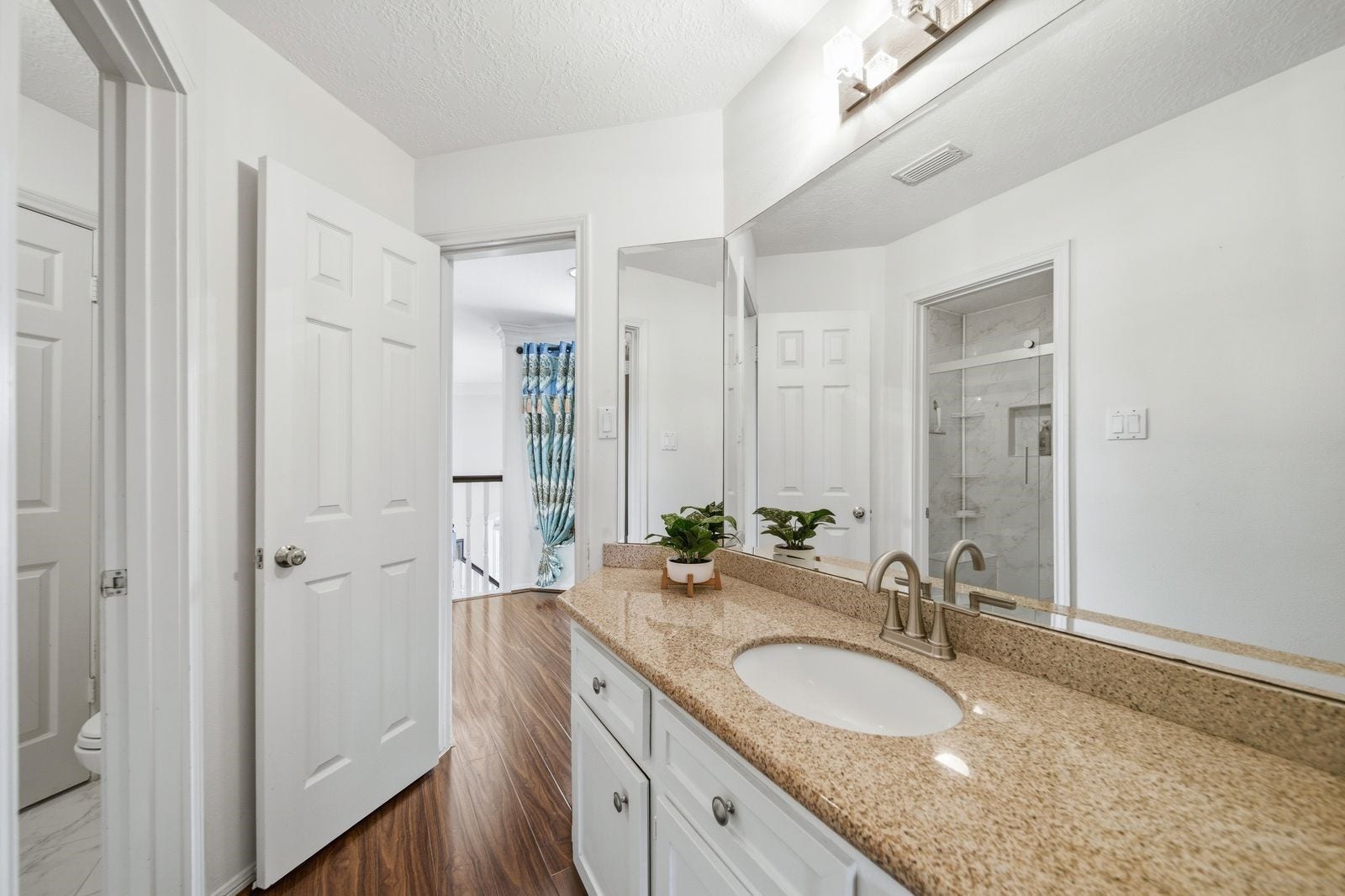 1606 Clearwater Creek Drive, Sugar Land, TX 77478 The upstairs bath has an updated shower with frameless glass enclosure.