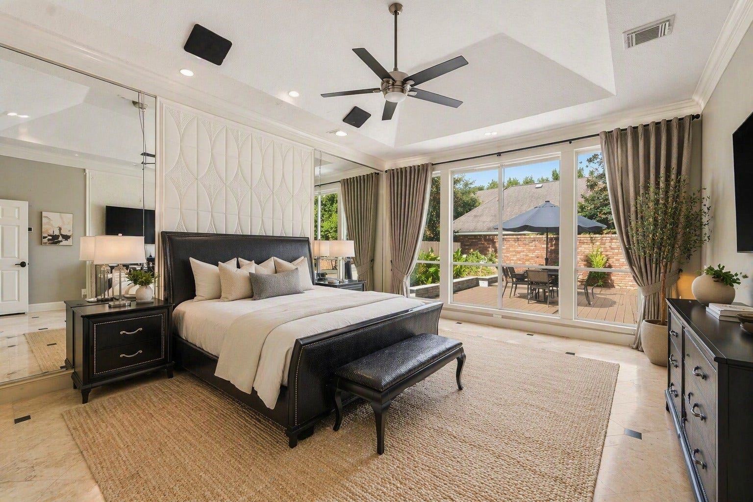 1606 Clearwater Creek Drive, Sugar Land, TX 77478 Virtually Staged. The primary suite is located on the first floor. Floor to ceiling windows, Travertine flooring. No carpet in this house.