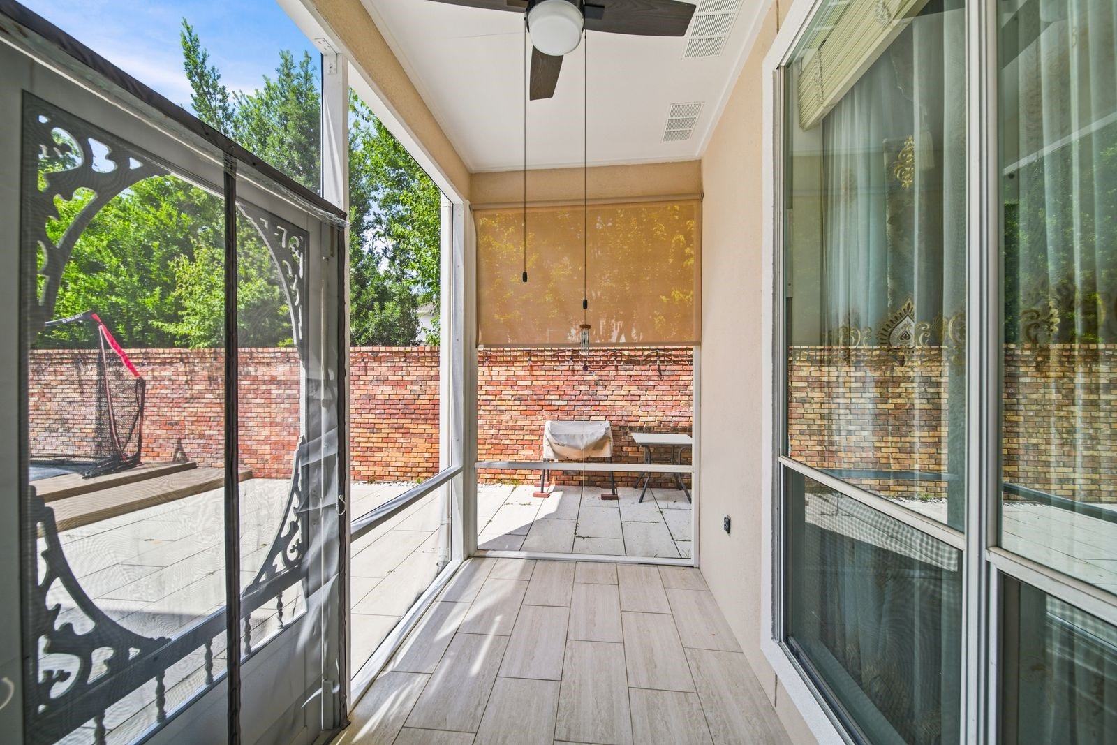 1606 Clearwater Creek Drive, Sugar Land, TX 77478 The screened in porch downstairs with ceiling fan. The backyard borders the Oyster Point neighborhood. The brick fencing provides great privacy and does not require homeowner maintenance.